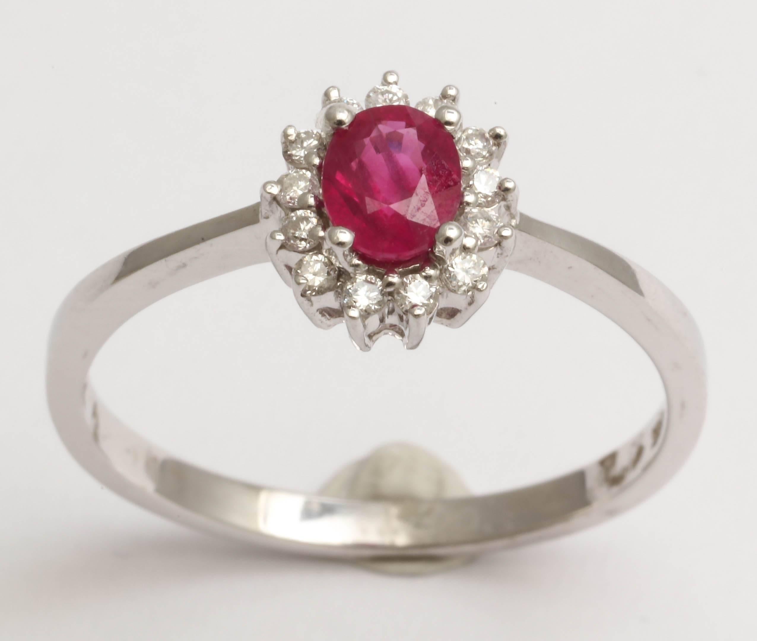 This charming ring is made in 14 kt white gold. The central ruby is .72ct and the diamonds .25cts. The ring is a size 7.5 now and can be sized. This ring matches earrings J6961611232175953fs and pendant J6961611232176003fs.