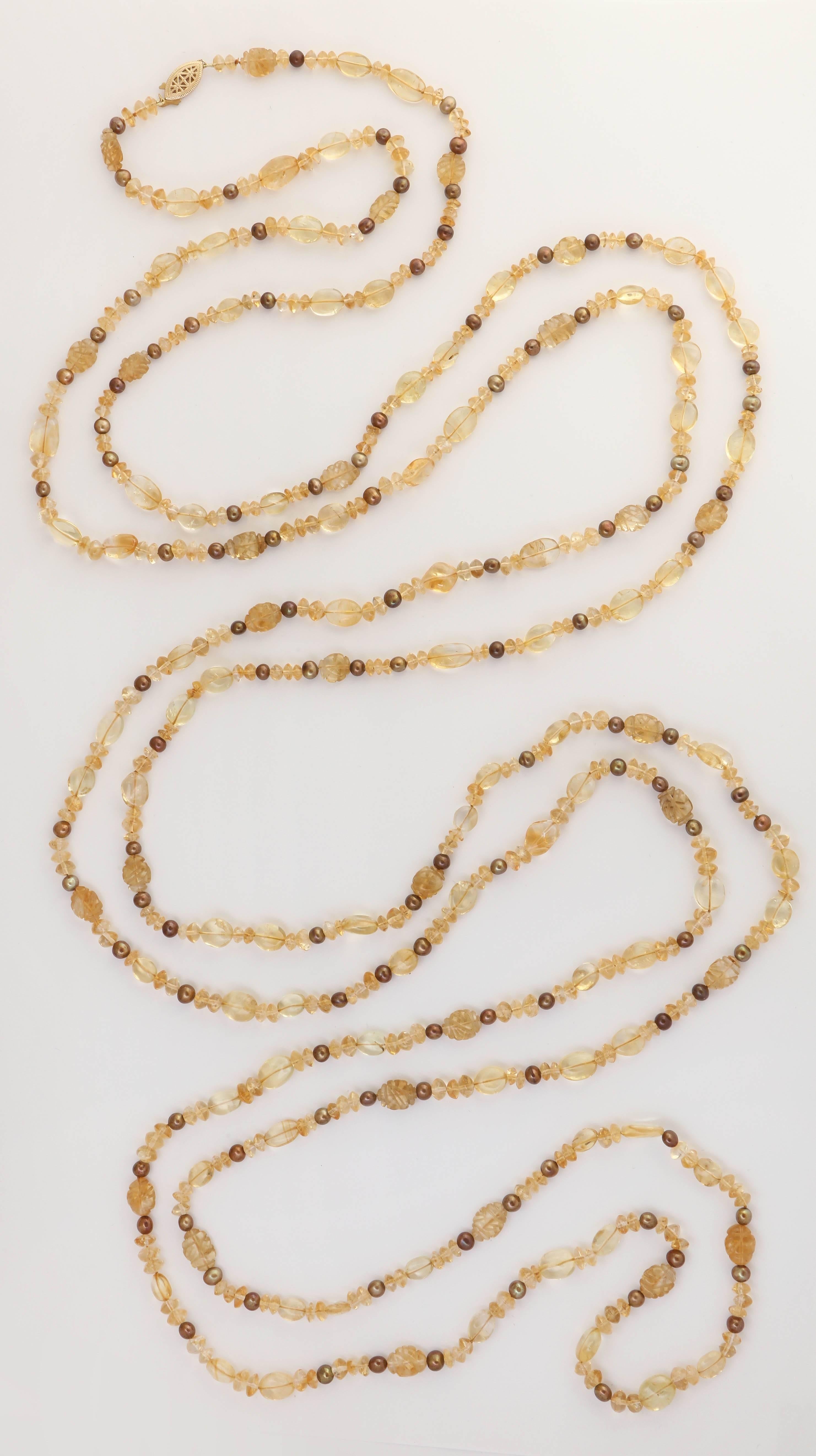 This is a very versatile necklace that can be worn many ways. There are a variety of shapes in the citrine beads, carved, oval, button shape, then interspersed with brown fresh water pearls. The necklace is finished with a 14 kt marquise clasp.