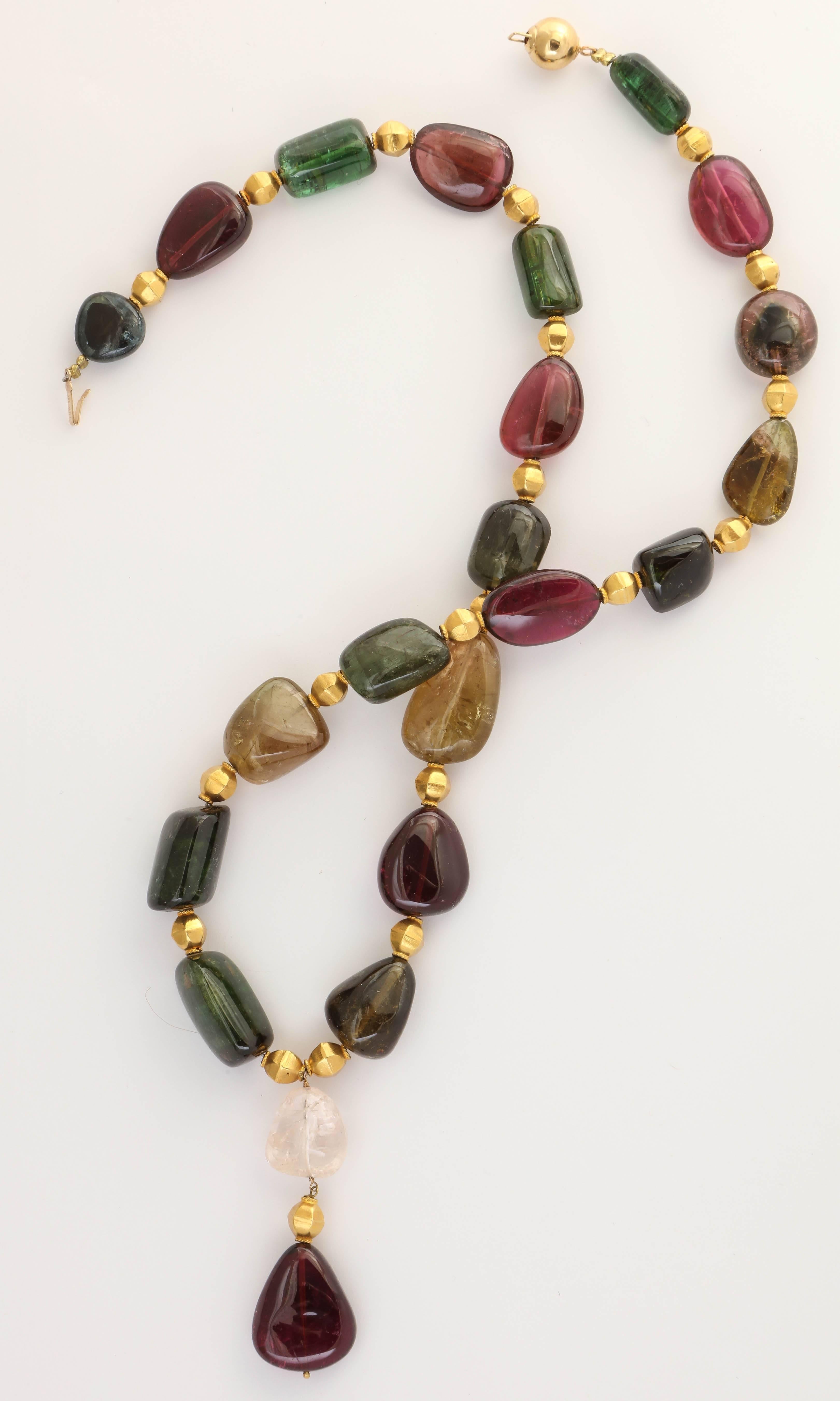 Beautiful large multicolored tourmaline beads divide by hand crafted 18 kt hexagonal gold beads. The total length is 20.5 in. not counting the center  pendant.  The beads average 3/4 in. in length. The tourmaline bead colors are bright and variant