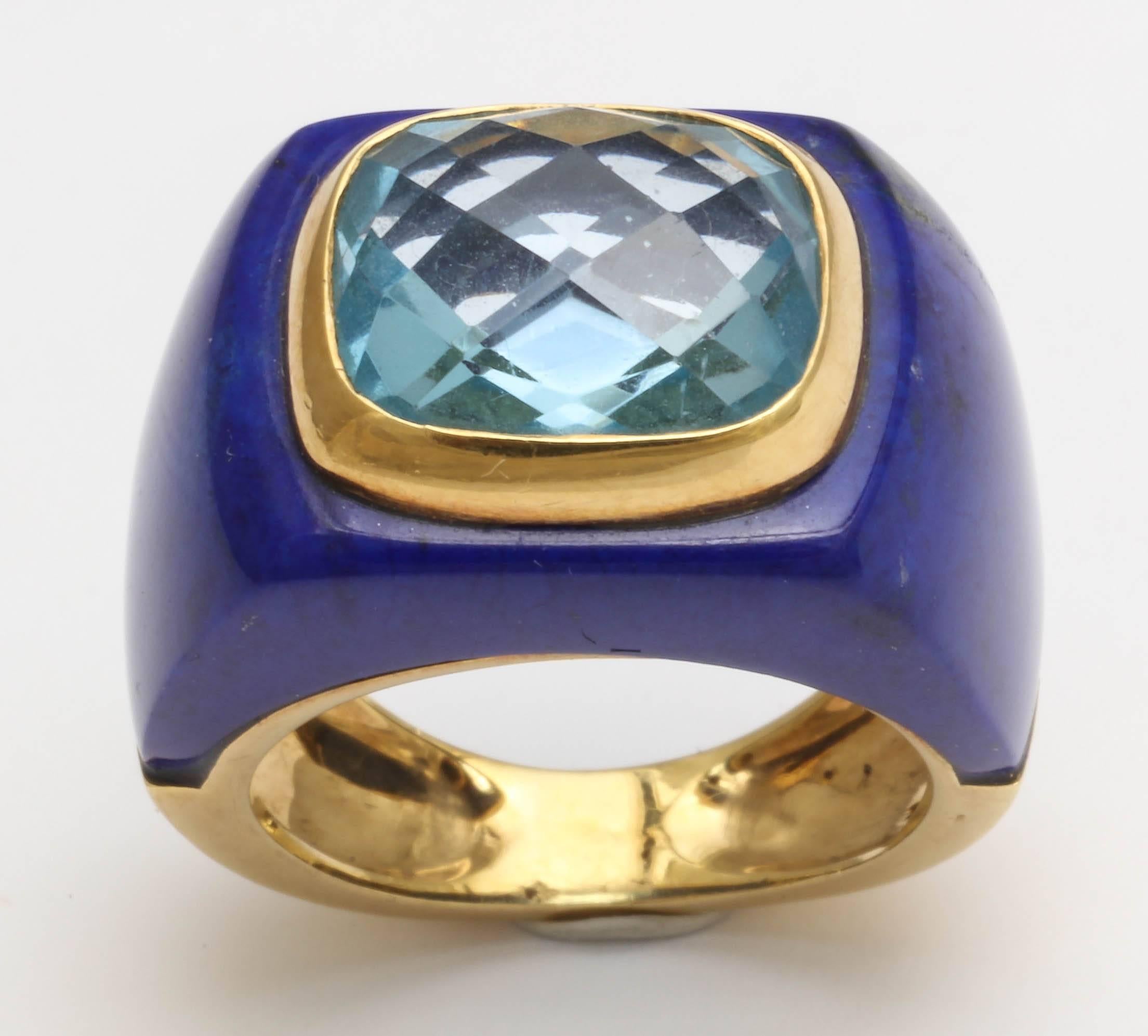 The center stone is a baby blue checkerboard cut 10 x 14 blue topaz.
It is bezel set and surrounded by custom cut top quality lapis lazuli. 
This ring is size 5.5 - 6 and cannot be sized.