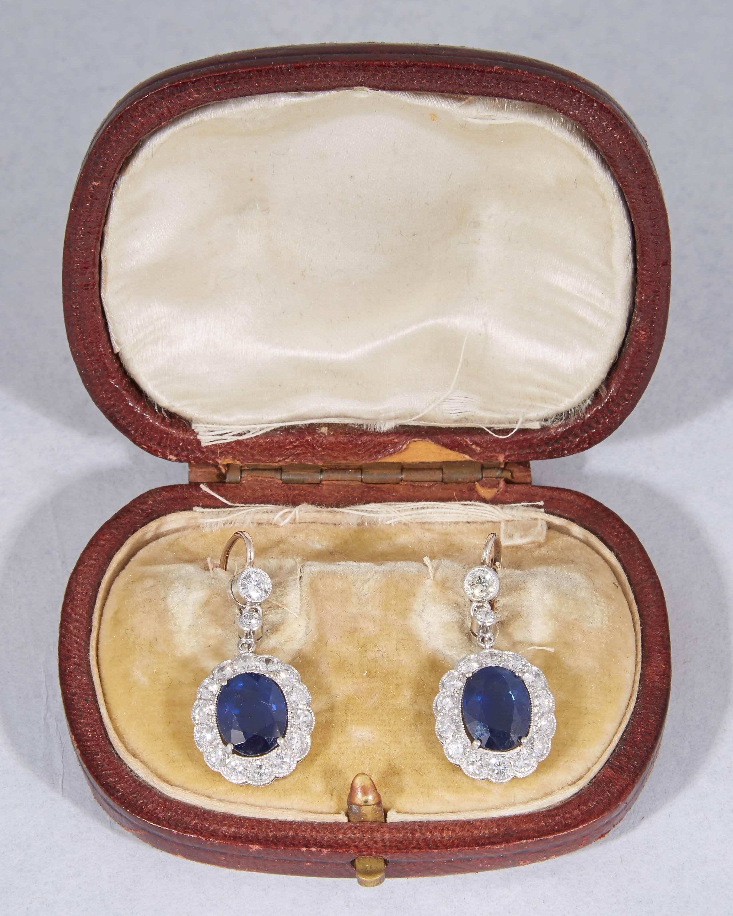 One Pair Of Ladies Drop Earrings Embellished With {2} Beautiful Color Scissor Cut Faceted Sapphires Weighing 3.25 Carats Each Totaling {6.50} Carats Total Weight ,& Further Embellished With Diamond Borders Weighing Over {2} Carats Of Diamonds