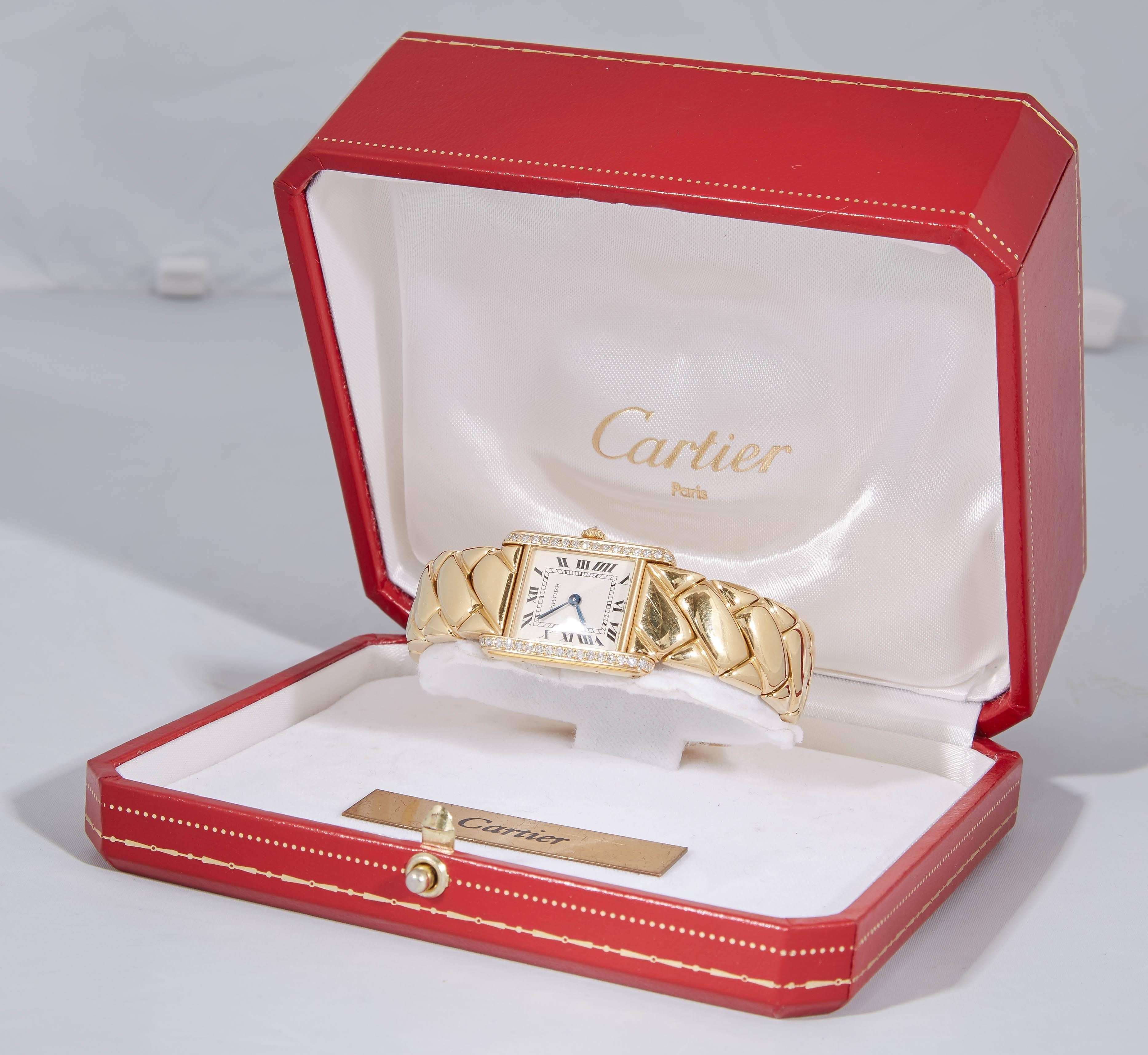 One Ladies Quilt/Woven Pattern Design Watch Designed By Cartier Paris Embellished With Numerous Full Cut Diamonds Weighing Approximately .50ct Total Weight. Made In 18kt Yellow Gold With A Deployant Clasp And Quartz Movement.