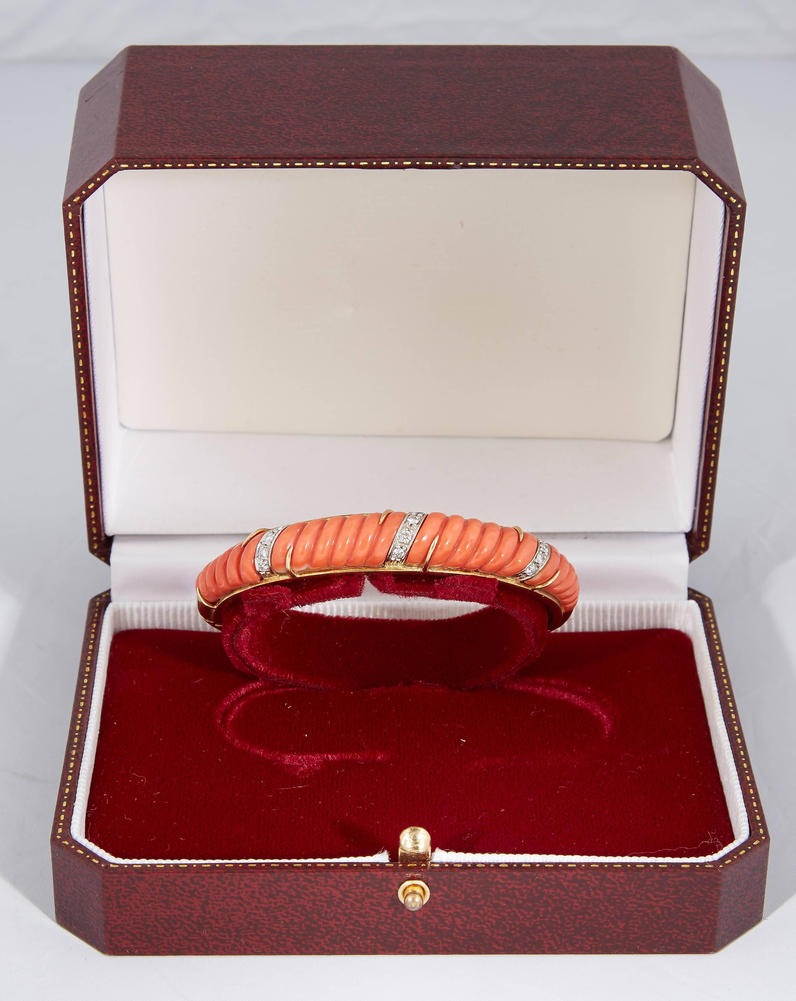 18kt Yellow Gold Bangle Bracelet Designed With One Large Custom Cut Fluted Coral Piece 9 Full Cut Diamonds Weighing Approximately .50 carats . Designed in the 1960's in The United States.