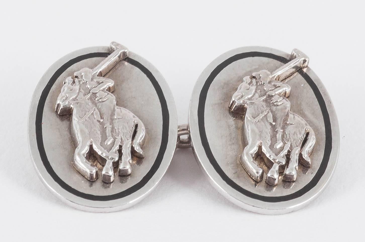 Pair of oval polo player cufflinks in 18ct white gold,with a black enamel border,signed AP  and Cartier,london hallmarked dated 1969