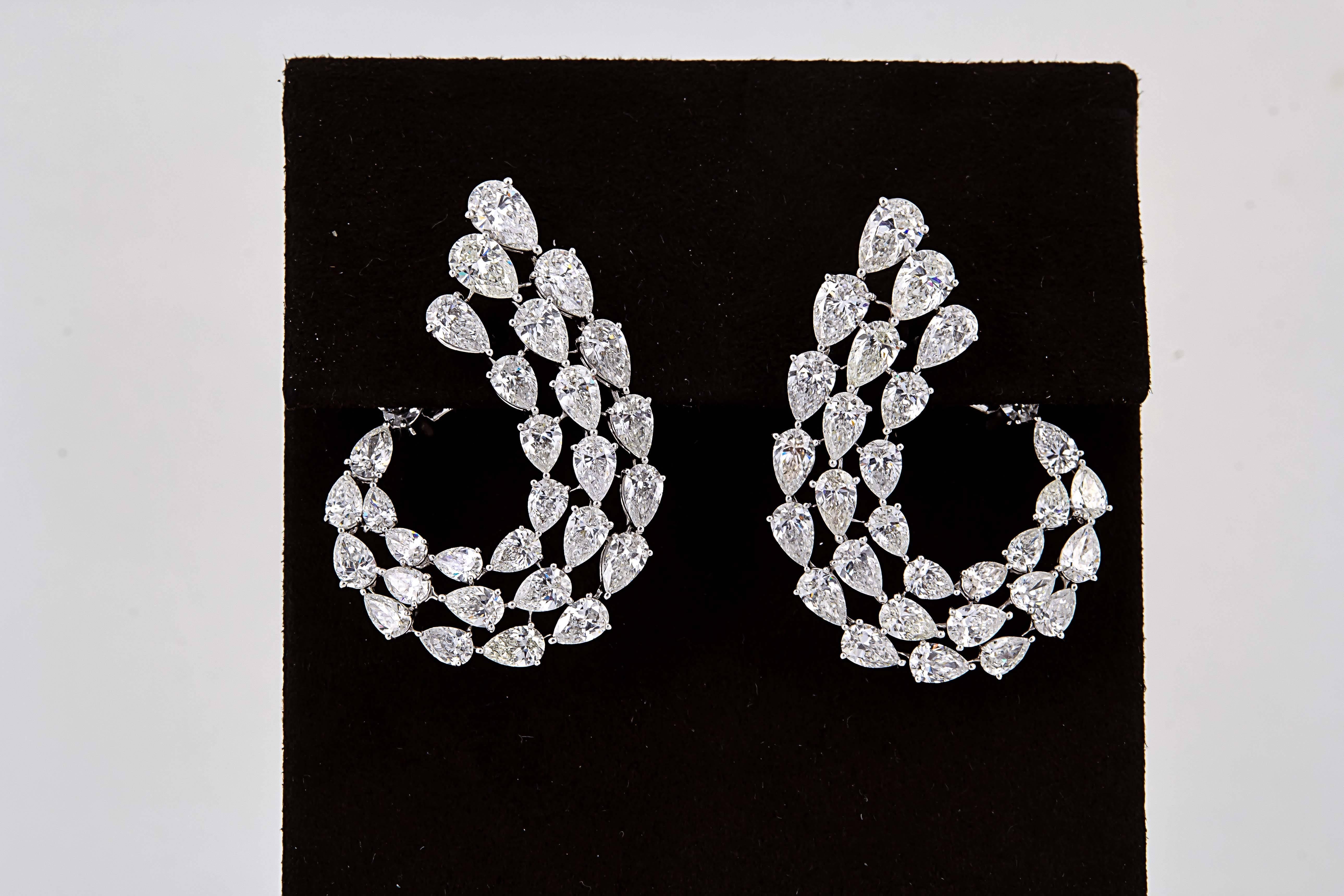 

An AMAZING pair of earrings! 

Designed and handcrafted by our skilled jewelers in New York, this earring is a WOW. 

15.49 carats of F/G color VS clarity pear shaped diamonds set in 18k white gold.

The earrings measure approximately 1.57