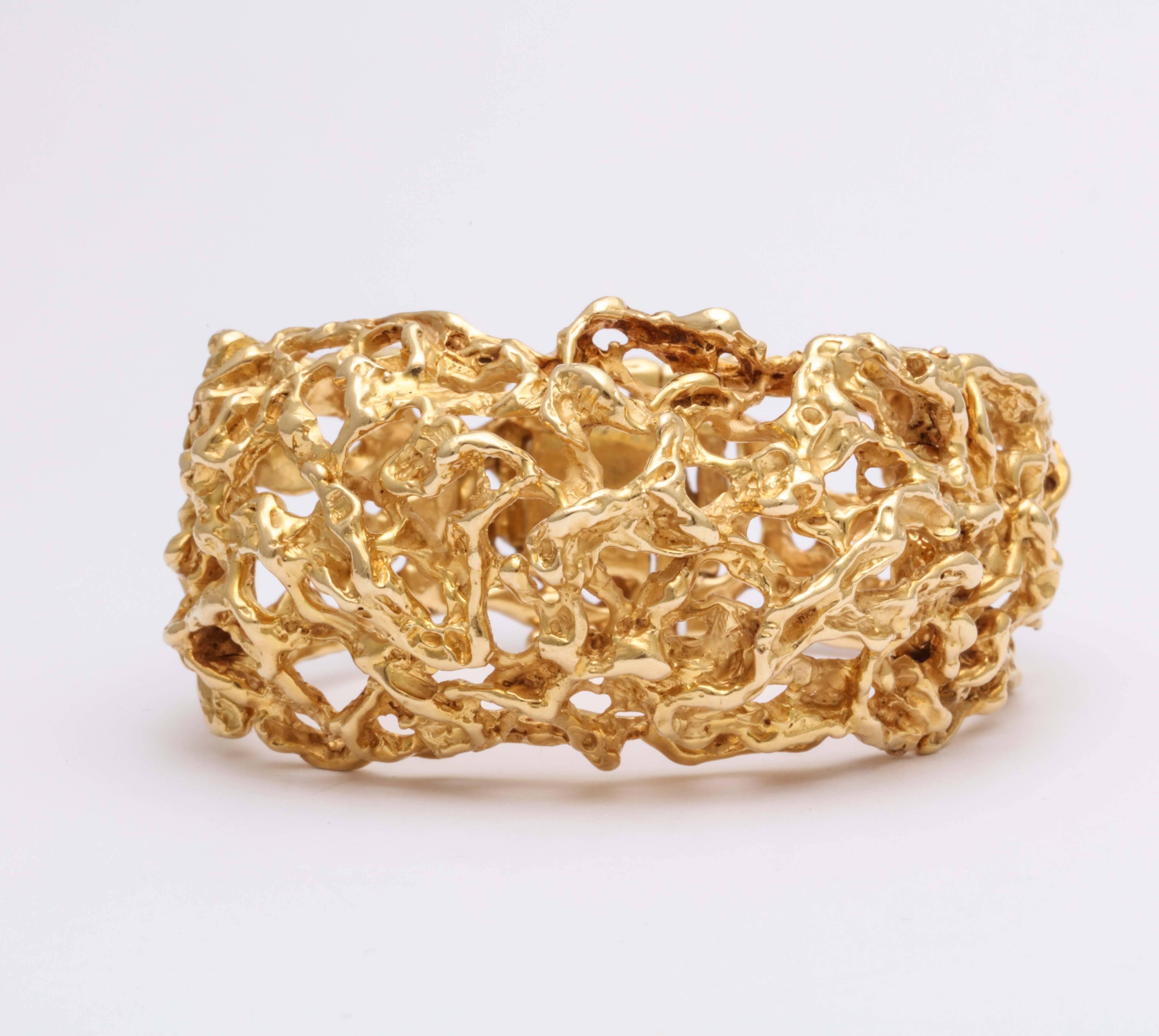 Wonderful openwork Bracelet with tabbed closing . Rigid - yet hinged in sections for mobility.  18kt Yellow Gold Center raised and then  hinged with two  flatter sections on either side.  Very organic. A classic work by this Greenwich Village Artist