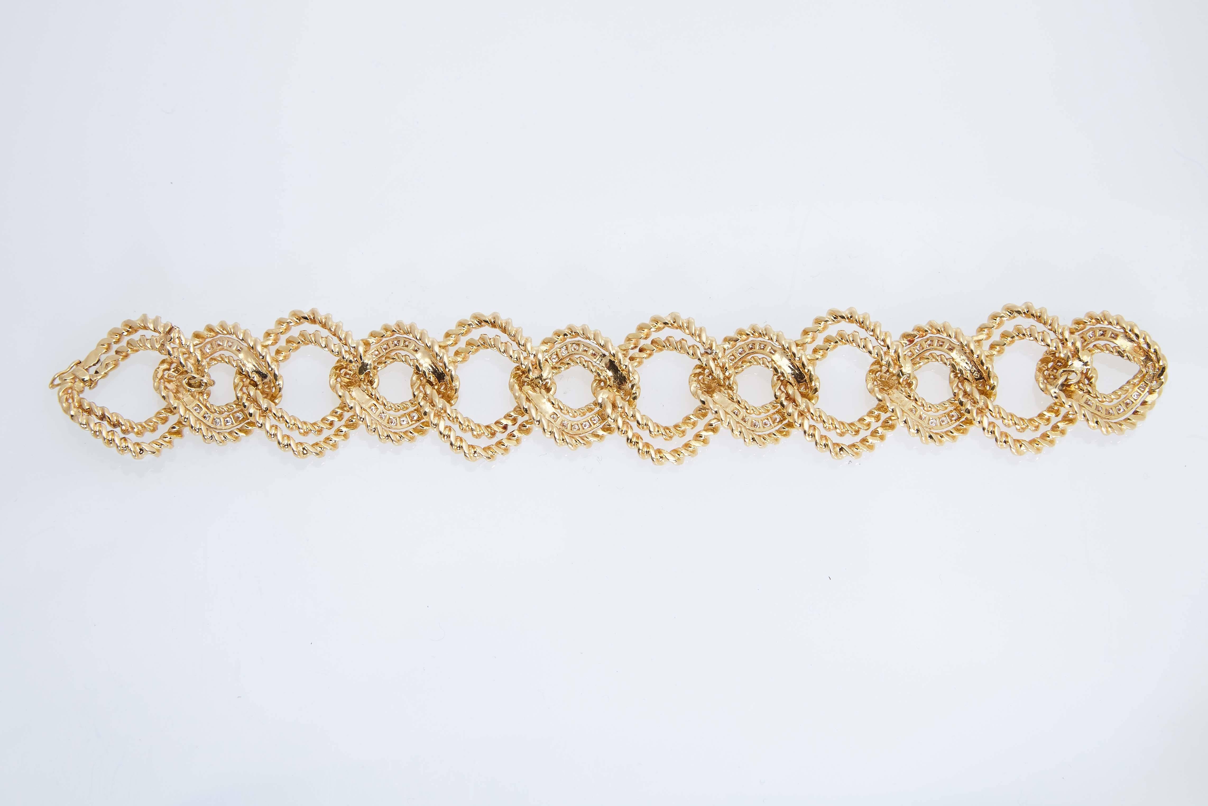 Van Cleef & Arpels eighteen karat yellow textured gold and diamond link bracelet.  The bracelet is 8" long and made up of 12 links. Six of the links have 120 diamonds in them with a total weight of approximately 3.00 carats.  The bracelet