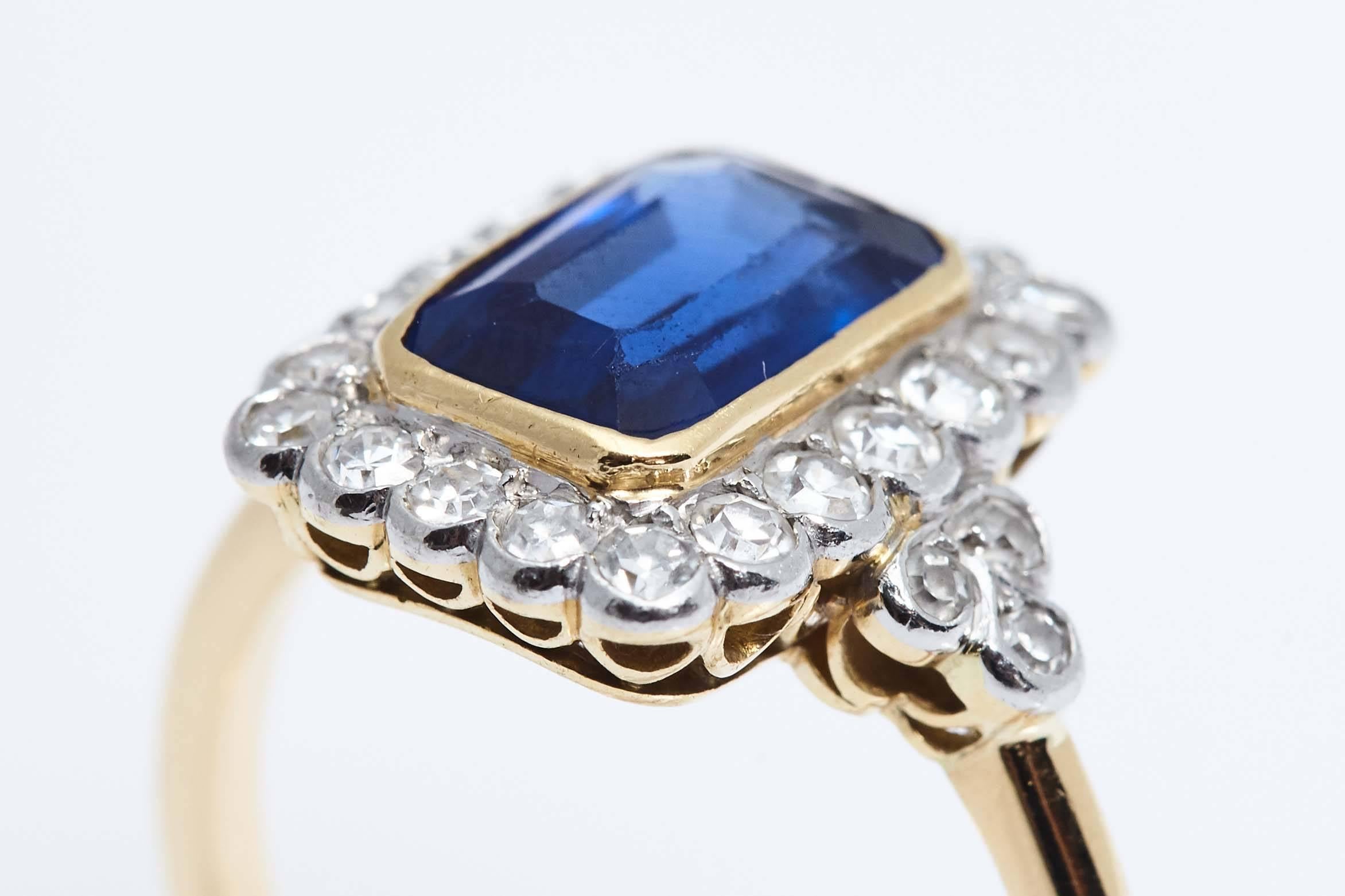 Rectangular Burma Sapphire weighing approximately 2.50 carats set in white and yellow 18 karat gold ring. The ring also has 26 round diamonds surrounding the Sapphire and in the shank of the ring.  The sapphire has no heat treatment. The ring is