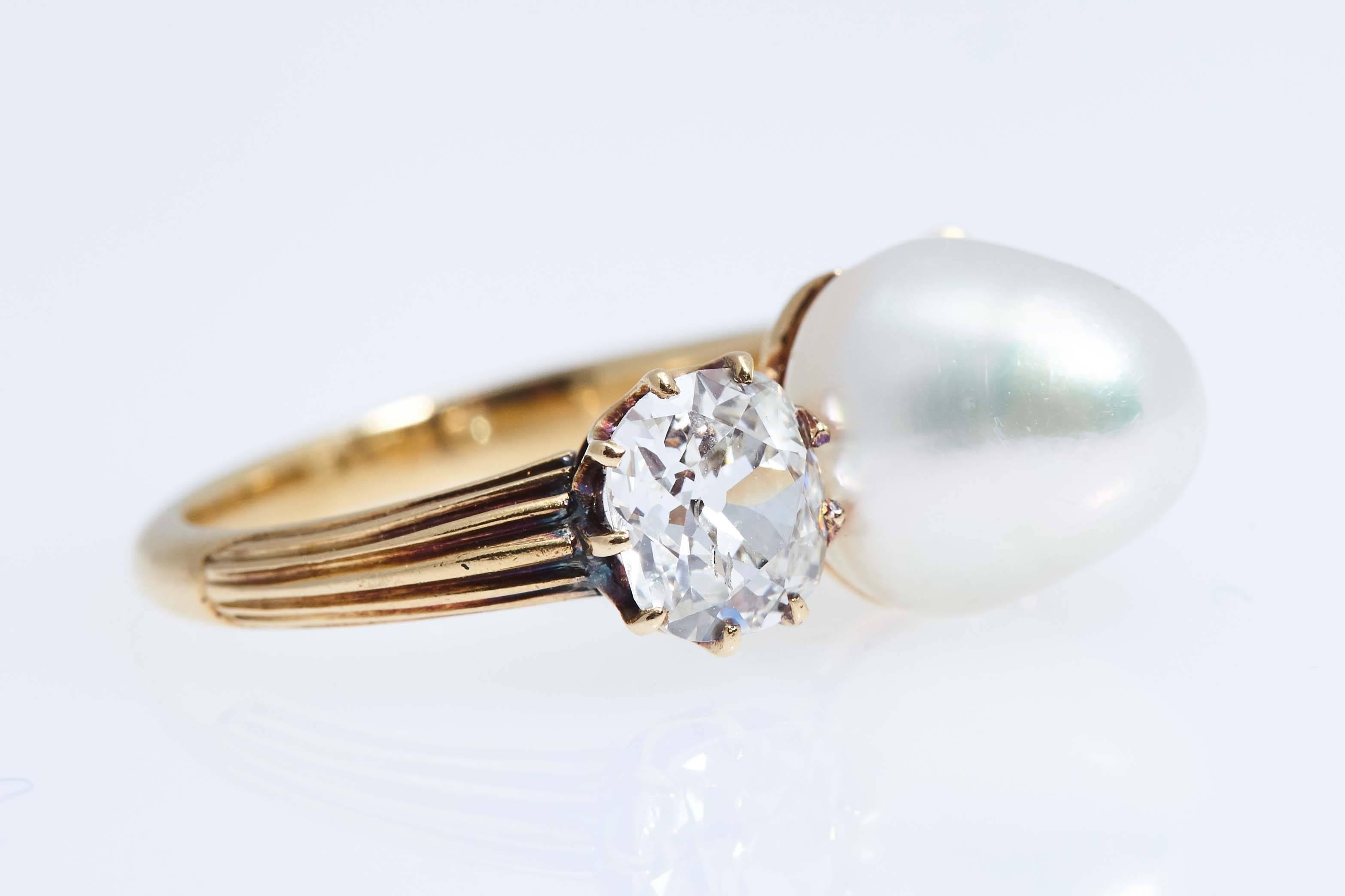 Antique natural pearl and diamond ring.  The two diamonds are old european cuts and weigh approximately 1.70 carats.  Finger size 5 1/4.