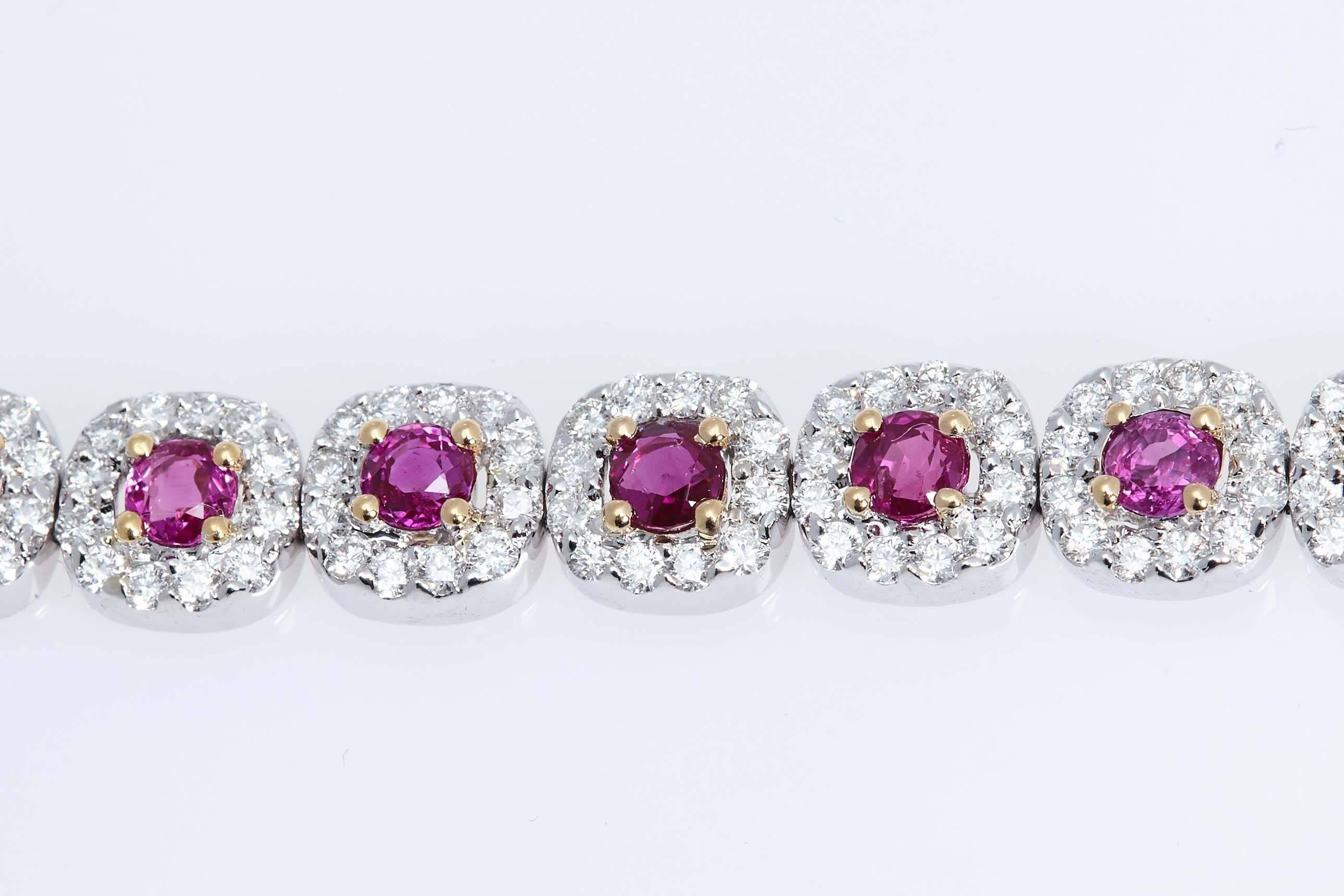 Eighteen karat white and yellow gold bracelet made up of twenty round Burmese rubies, each ruby is encircled by 12 round diamonds. The rubies have a total weight of 6.93 carats and the diamonds have a total weight of 4.84 carats. The rubies are set