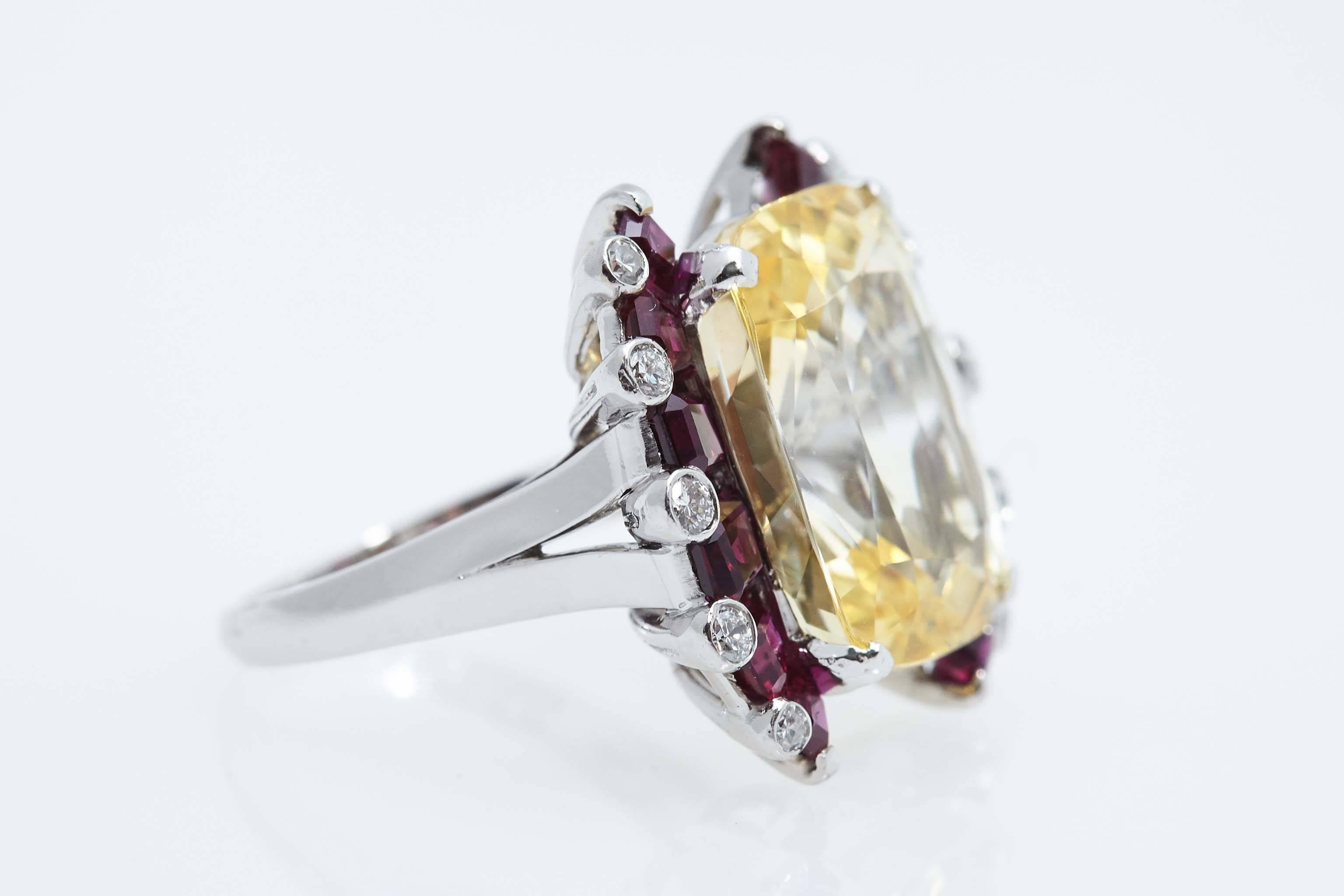 Oscar Heyman platinum, yellow cushion shaped sapphire, ruby and diamond ring. The yellow sapphire has a report from the GIA stating that it weighs 17.33 carats, is natural and that there is no indication of heat treatment. The ring is accompanied by
