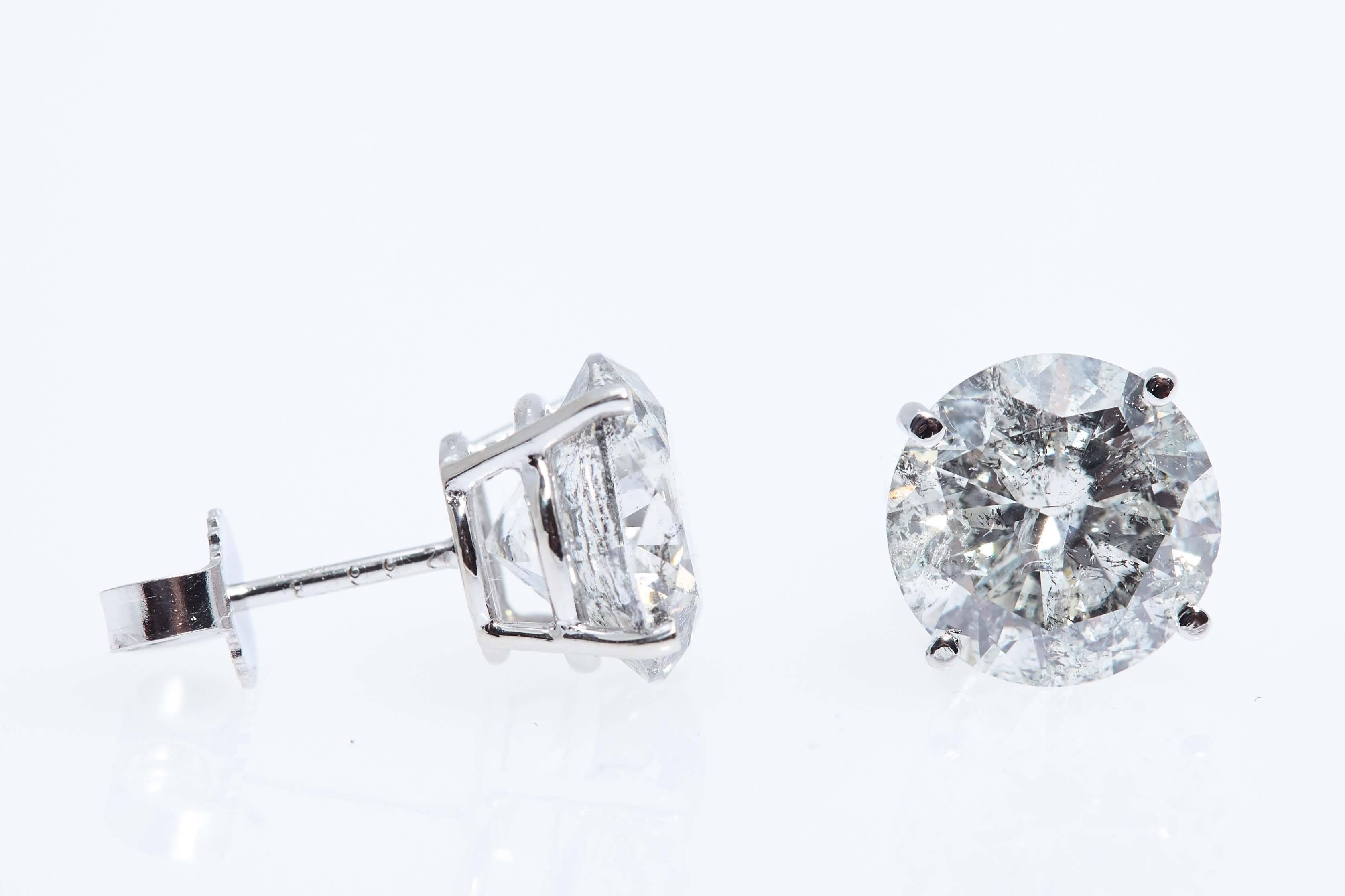 Perfect earrings if you want flash for your money.  Total weigh of the the two round diamonds is 5.42 carats and they are mounted in simple 14 karat white gold earrings. 
