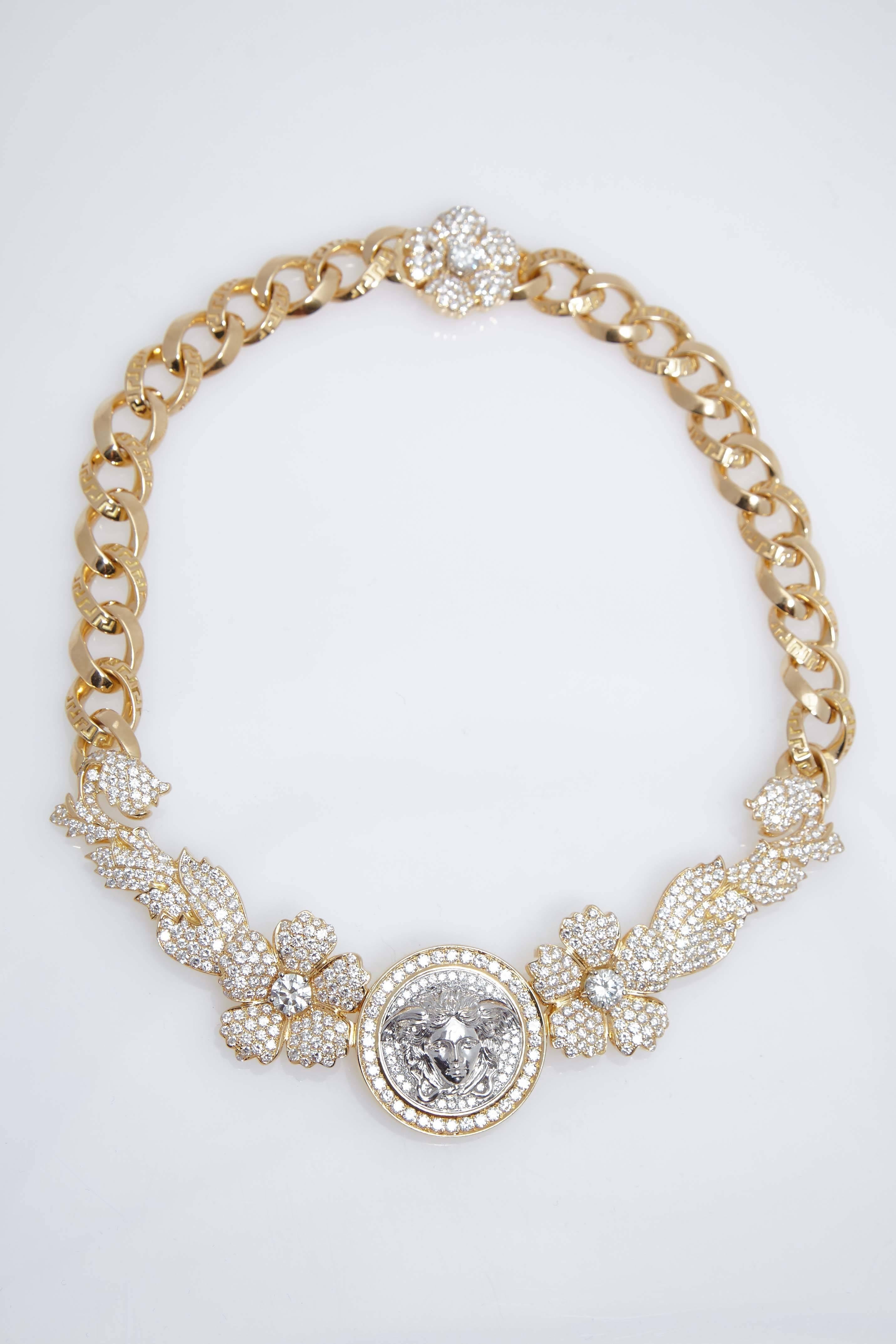 Versace eighteen karat yellow gold and diamond "Tiara" necklace designed by Gianni Versace. Necklace contains approximately 24.24 carats in round diamonds. Necklace is numbered "002"  The three largest stones in the necklace are