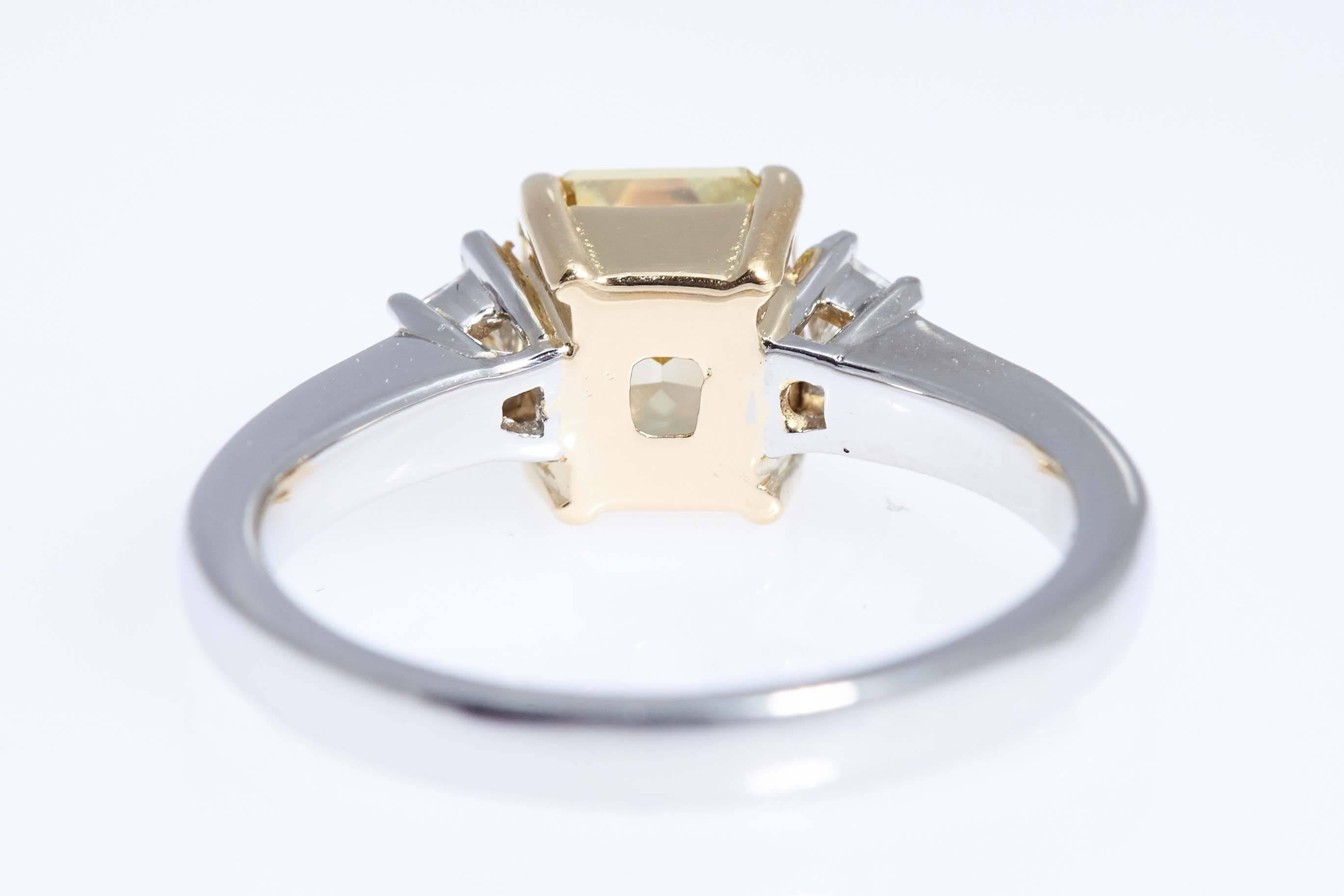 Women's GIA Intense Yellow 1.62 Carat Emerald Cut Diamond Platinum Three-Stone Ring For Sale