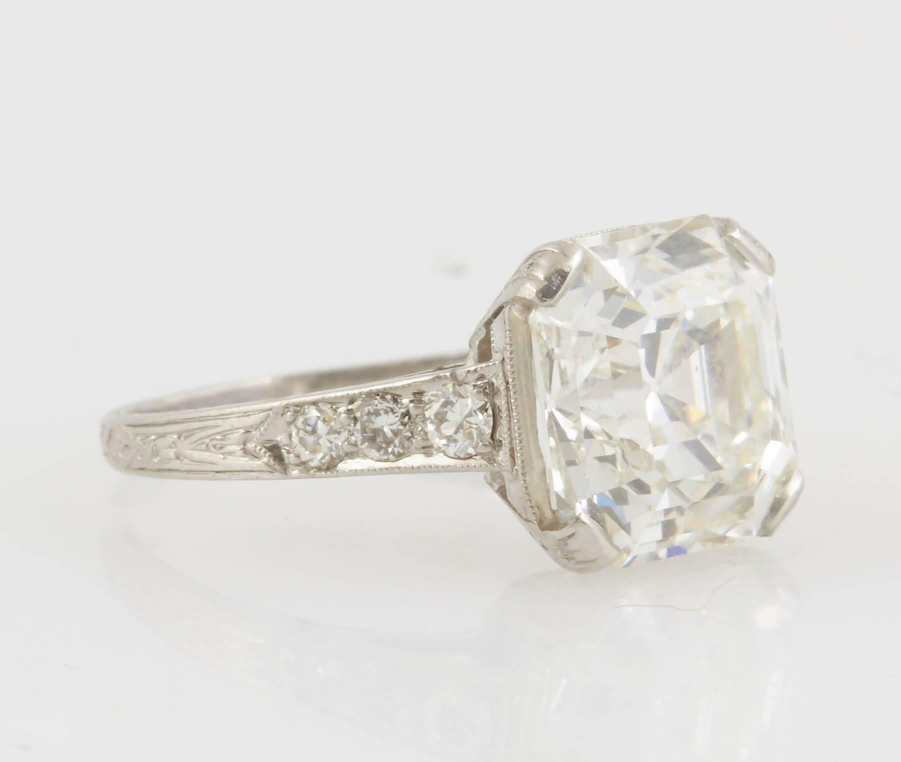 Antique Engagement ring, finely crafted in platinum with GIA certified Asscher cut diamond at the center, weighing 3.97 carat, J Color VS1 Clarity.