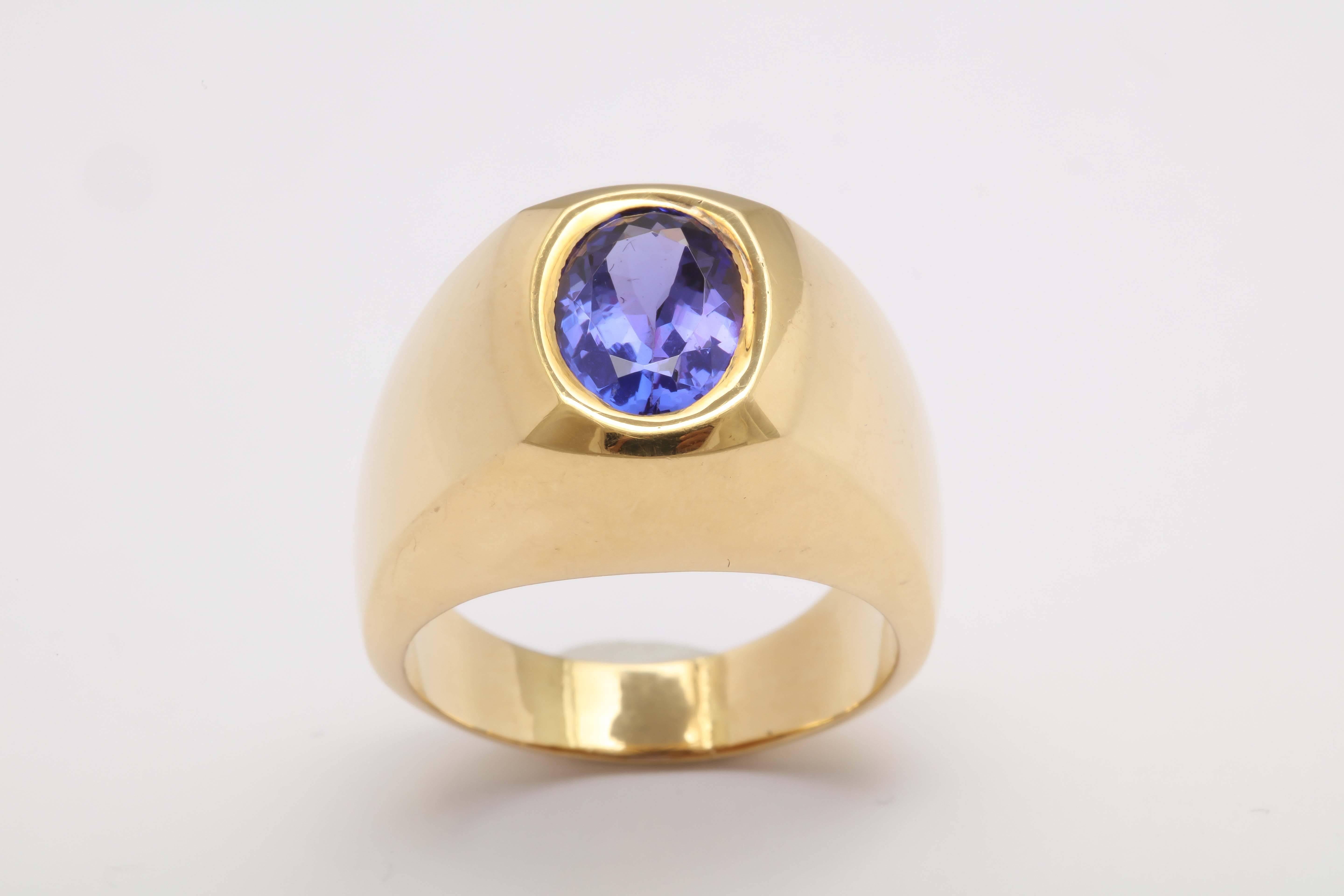 Simple but elegant.   Faced Tanzanite Ring set in elegant 18 kt Yellow Gold Architectural  Mounting.  Very much of a statement.  Can be worn by either Sex.
Size 11 but can be sized.  Beautiful lively stone 