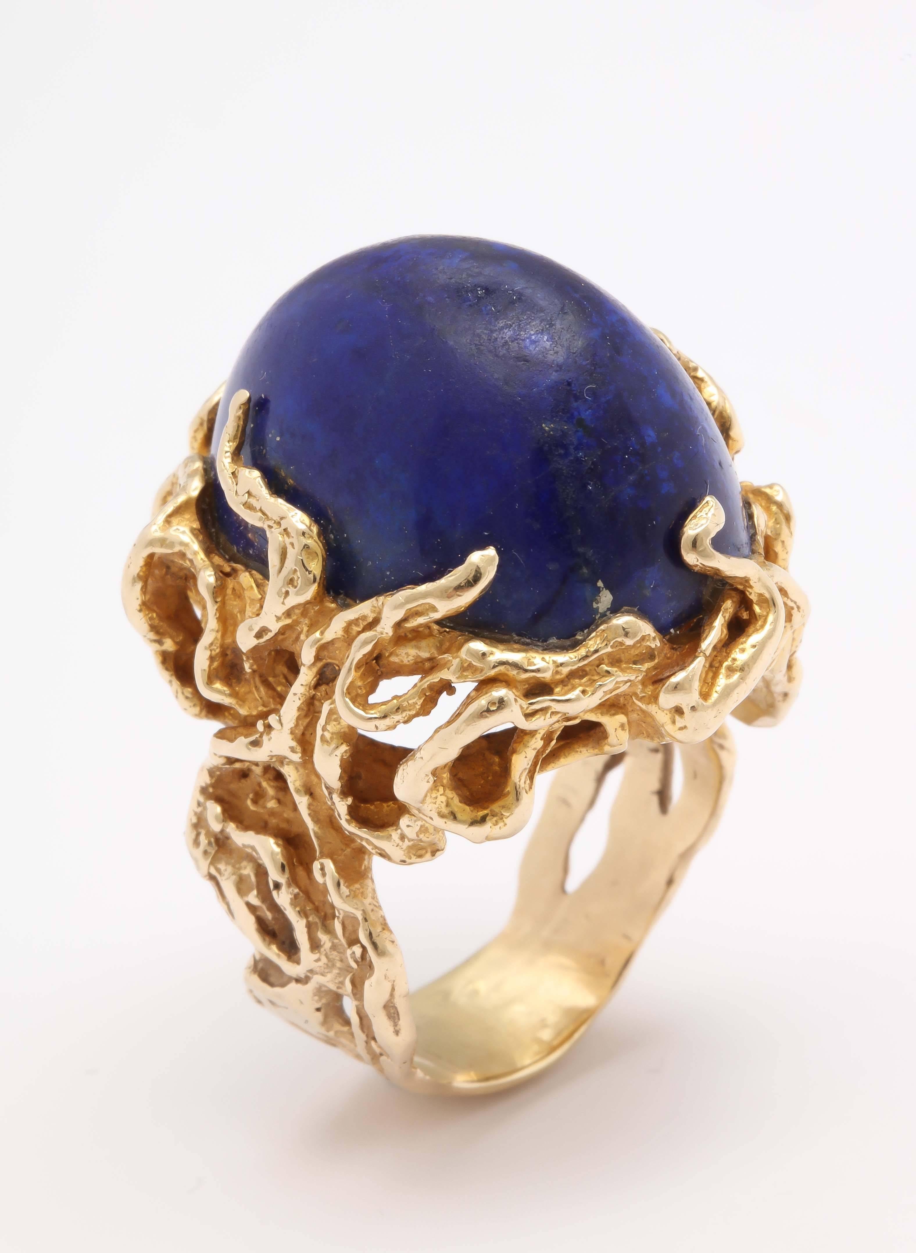 Large 50's 14kt kt Yellow Gold Branch setting, within which sits a large Cabochon Lapis Lazuli Oval stone. This certainly makes a statement.  Can be worn on an index or ring finger defending on how much attention that you want to attract. Fits a