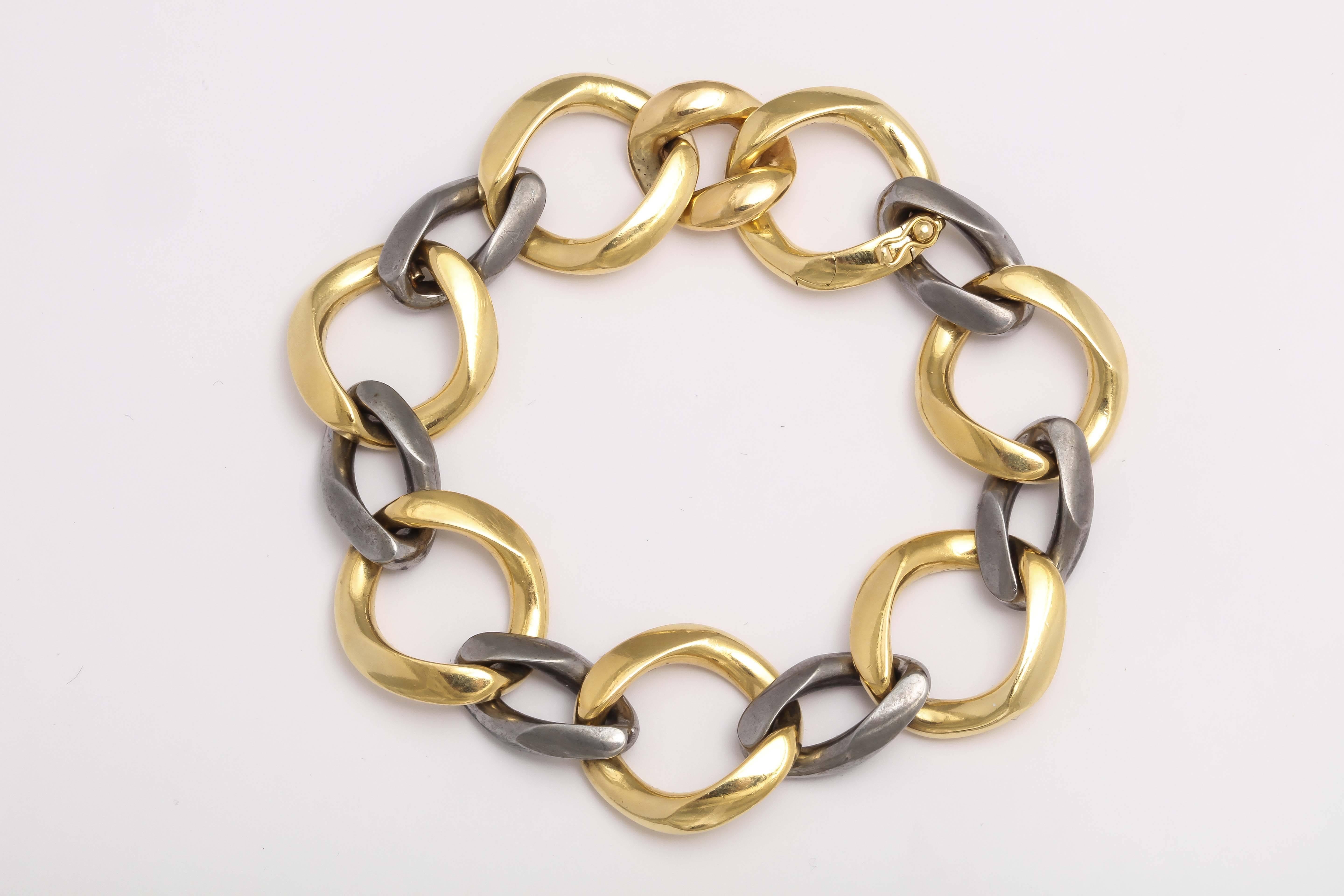 Ultra chic Bracelet with 8 - 18kt Yellow Gold Links attached by 6 Gun Metal Paper link shaped links to give a bold new look by the combination of metals.  Clasp is self closing link with safety.  Beautifully made. Marked 750 and 18kt Fred Paris.  So