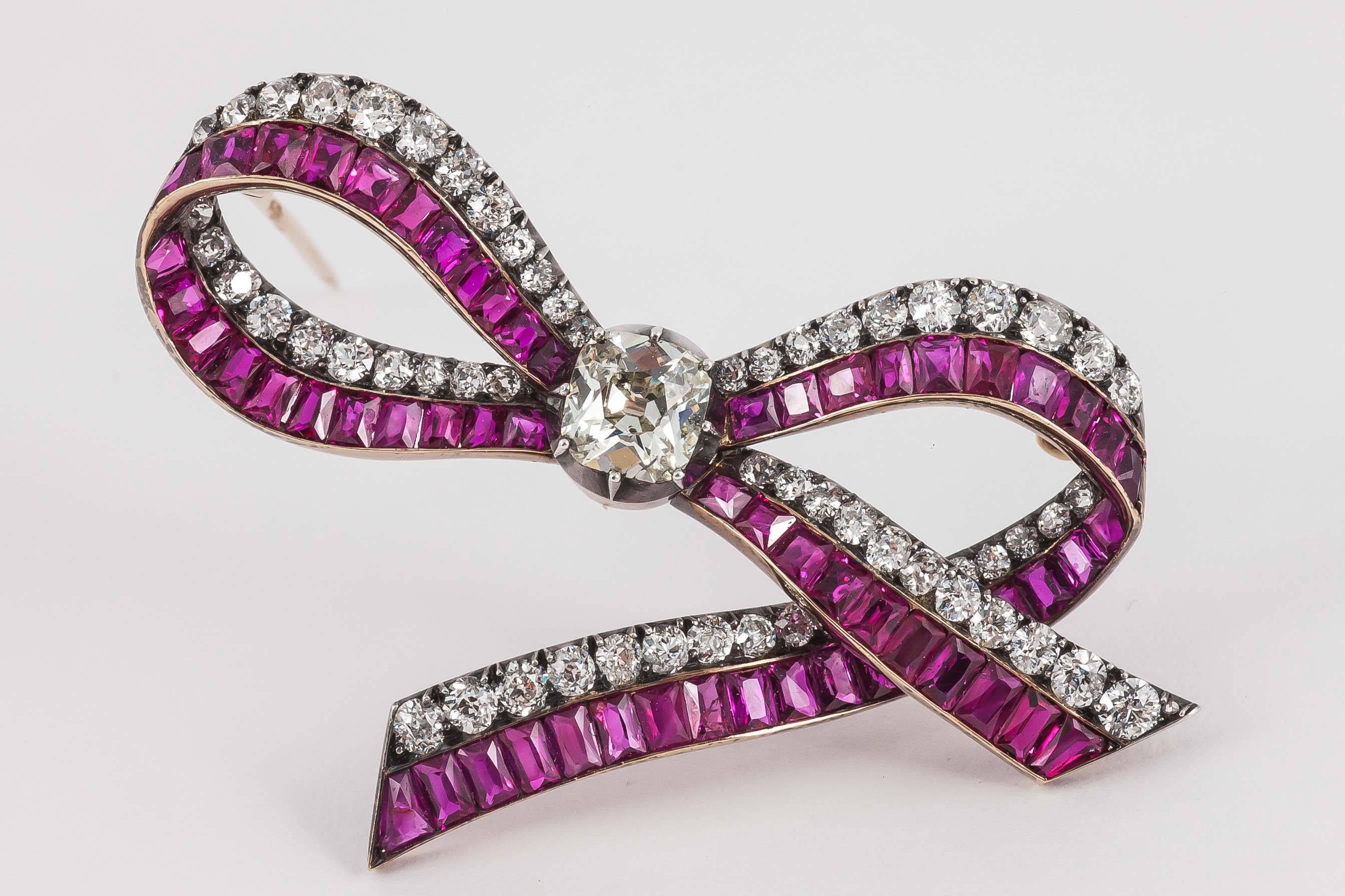 A very fine Austrian,tied ribbon brooch,set with old cut brilliant diamonds.and channel set,shaped Burma Rubies,mounted in silver and gold,c,1870.The brooch fitting detachable.