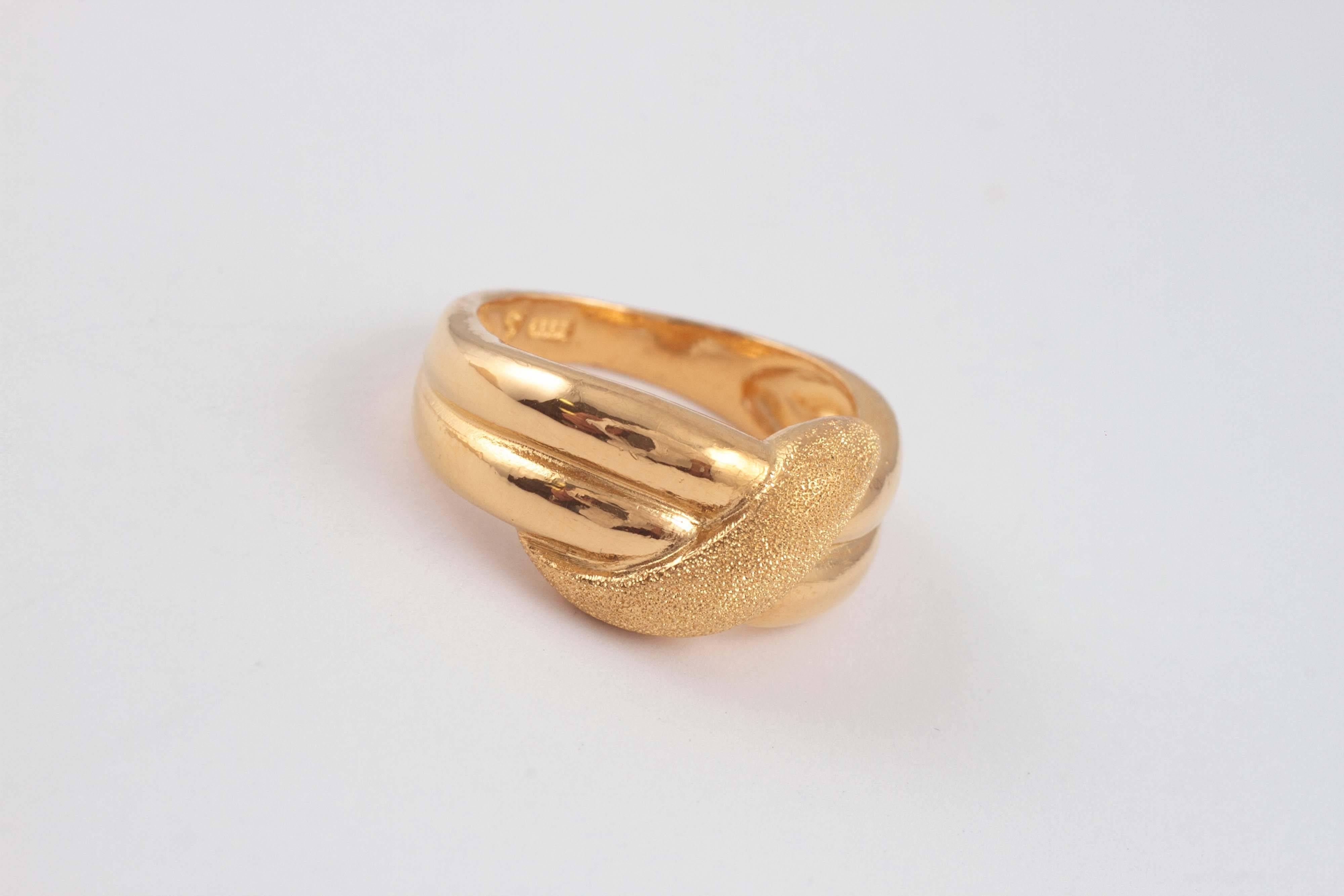 In a textured and highly-polished style, 22 karat, in size 8 1/4.