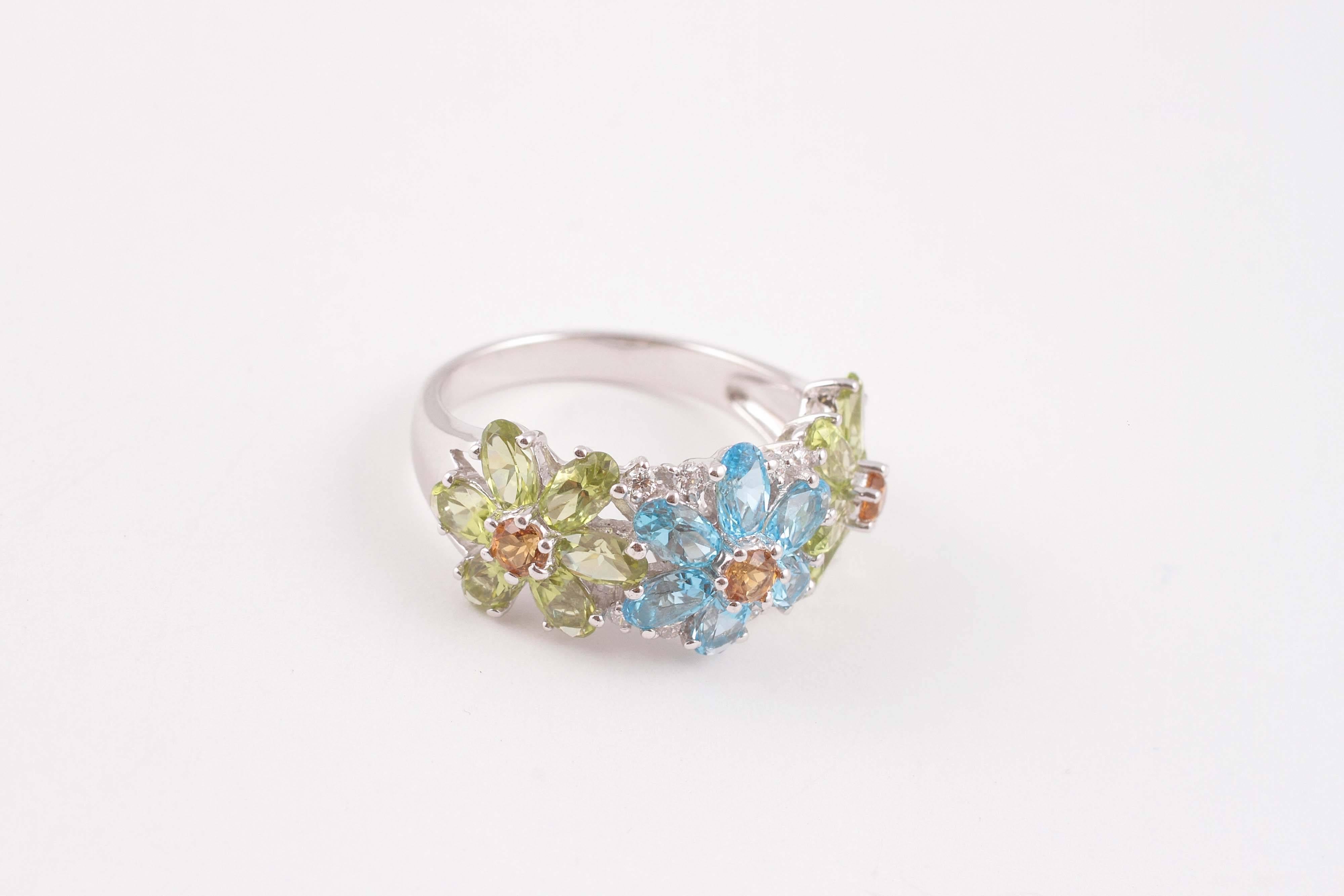 What a fun Flower ring!  With bright and shining topaz, peridot and citrine stones, in 14 karat white gold, Size 9.