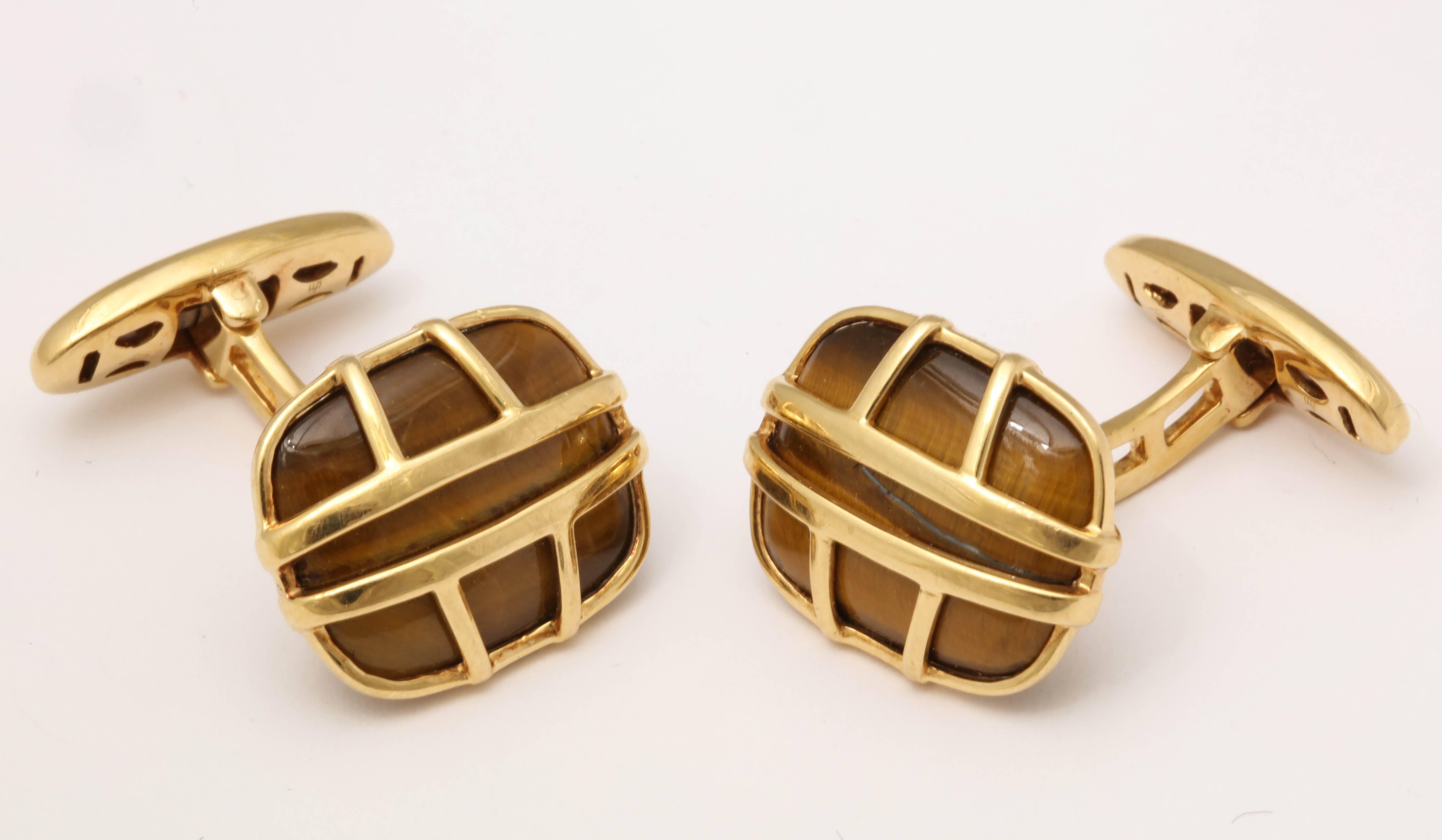 One Pair Of Gentlemen's 18kt Yellow Gold Flip Up And Flip Down Easy wear cufflinks Designed with Two Large Cushion Shaped Oval Tiger's Eye Stones Measuring approximately 22Mm Each Stone Set In A Cage Effect Gold workmanship Style Design.. Designed