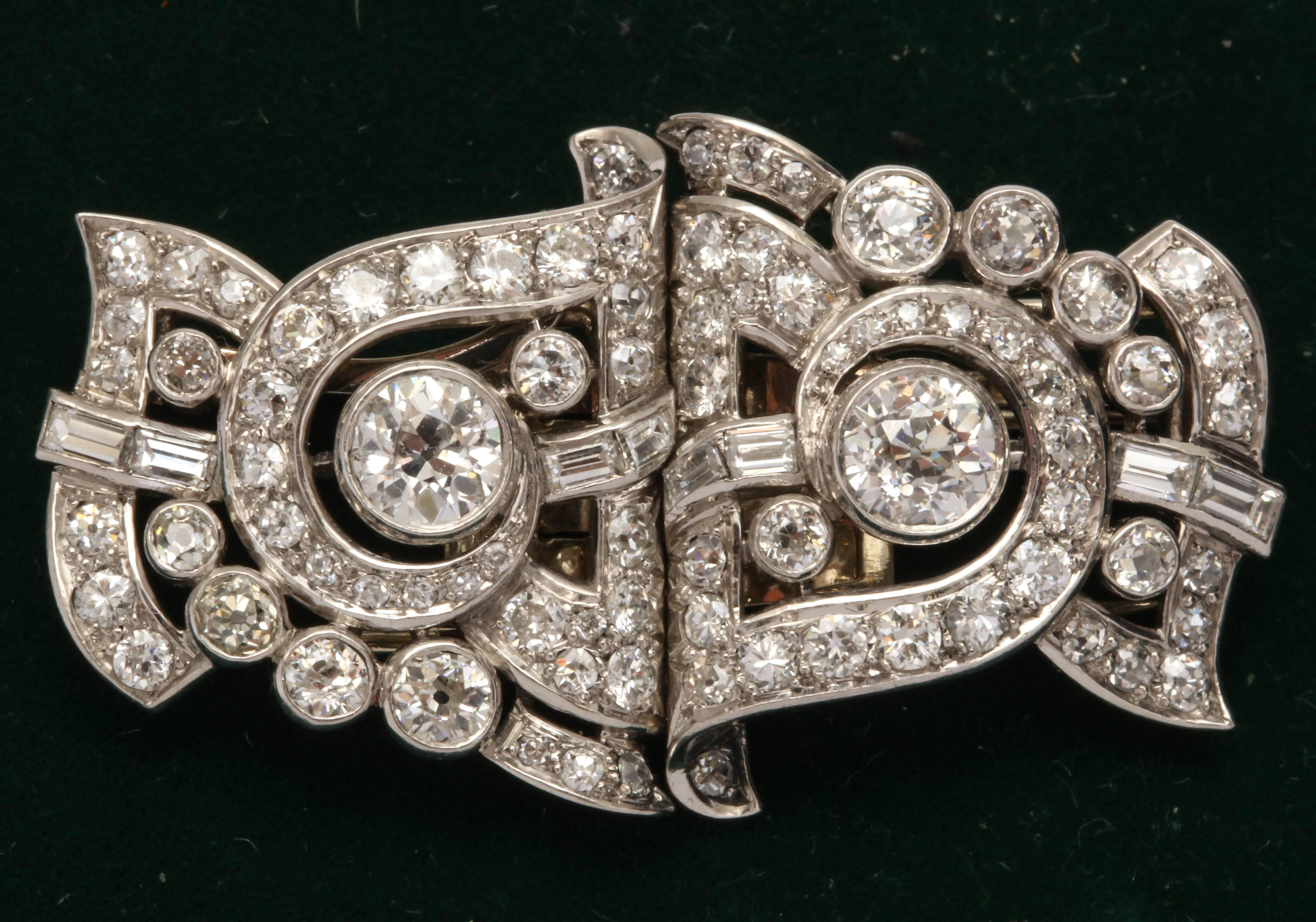 One Pair Of Platinum And Diamond Ladies Clips And Brooch Combination Pins Embellished with Numerous Full Cut Round Diamonds And Further embellished With Eight Custom Cut Fancy Baguette Cut Diamonds Total Diamond weight Approximately 4 Carats. Center