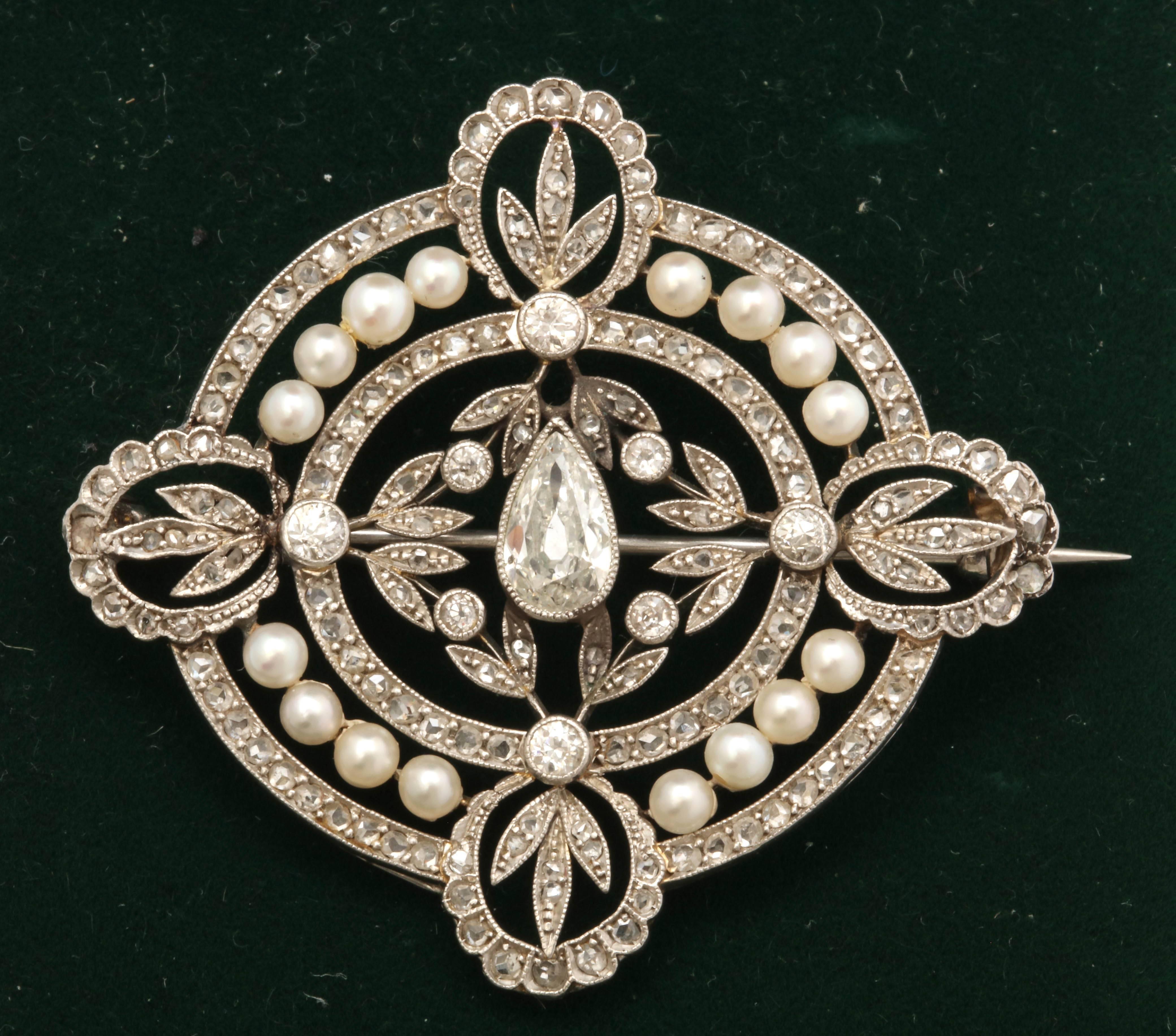 One Ladies Open Work Brooch From The Edwardian Era Decorated With Numerous Antique Cut Diamonds With A Center Pear Shaped diamond Approximately Measuring .80Cts and Numerous Antique Cut Diamonds Weighing Approximately 2 Carats. Further Designed With