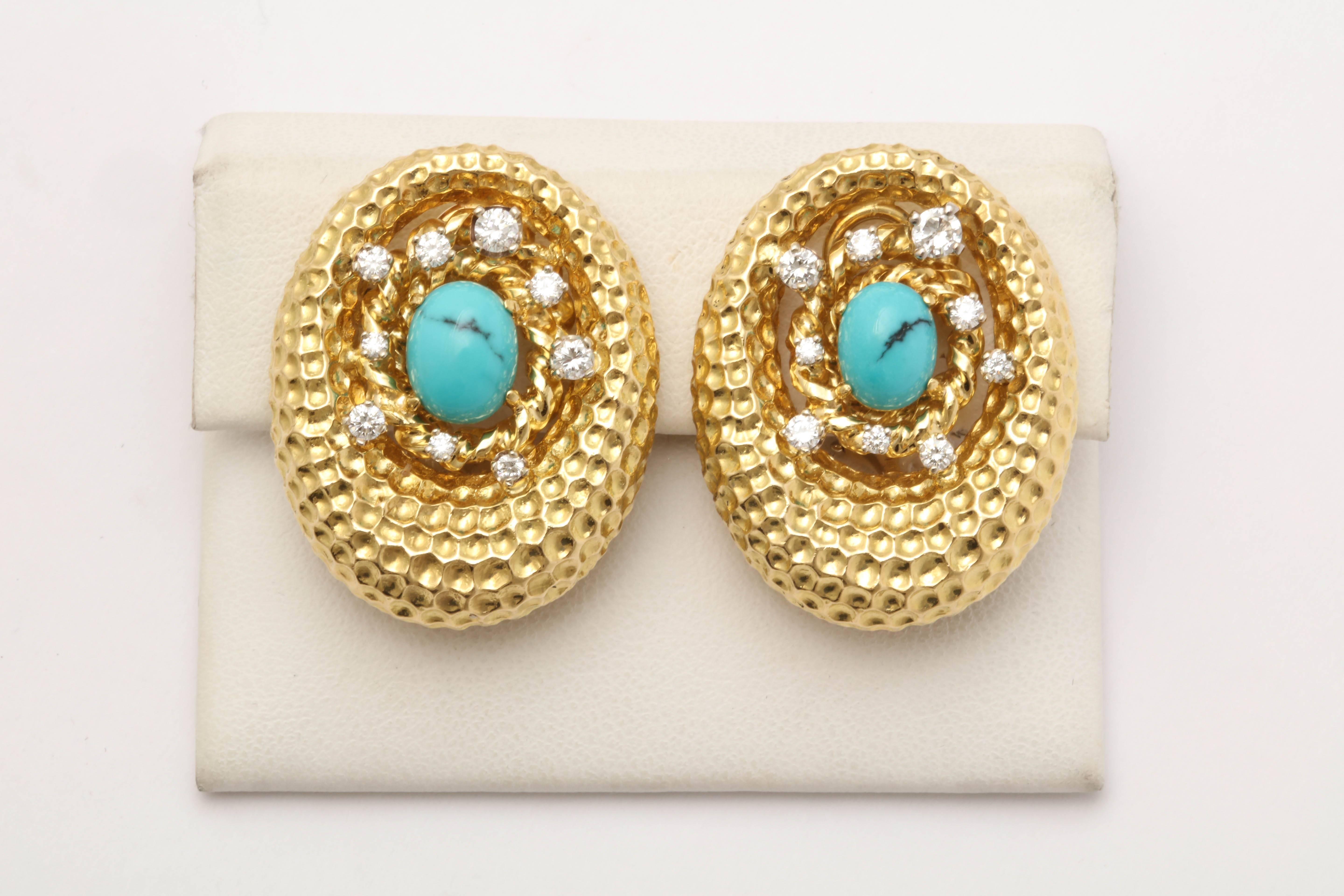 18kt Gold Oval Shaped Clip On Earrings Embellished With 18 Full Cut Diamonds Weighing Approximately 1.50 Cts Total weight. Further Designed With Two 5 Mm Oval Cut Natural Turquoises. Gold Workmanship Consisting Of Beautiful Crater Design