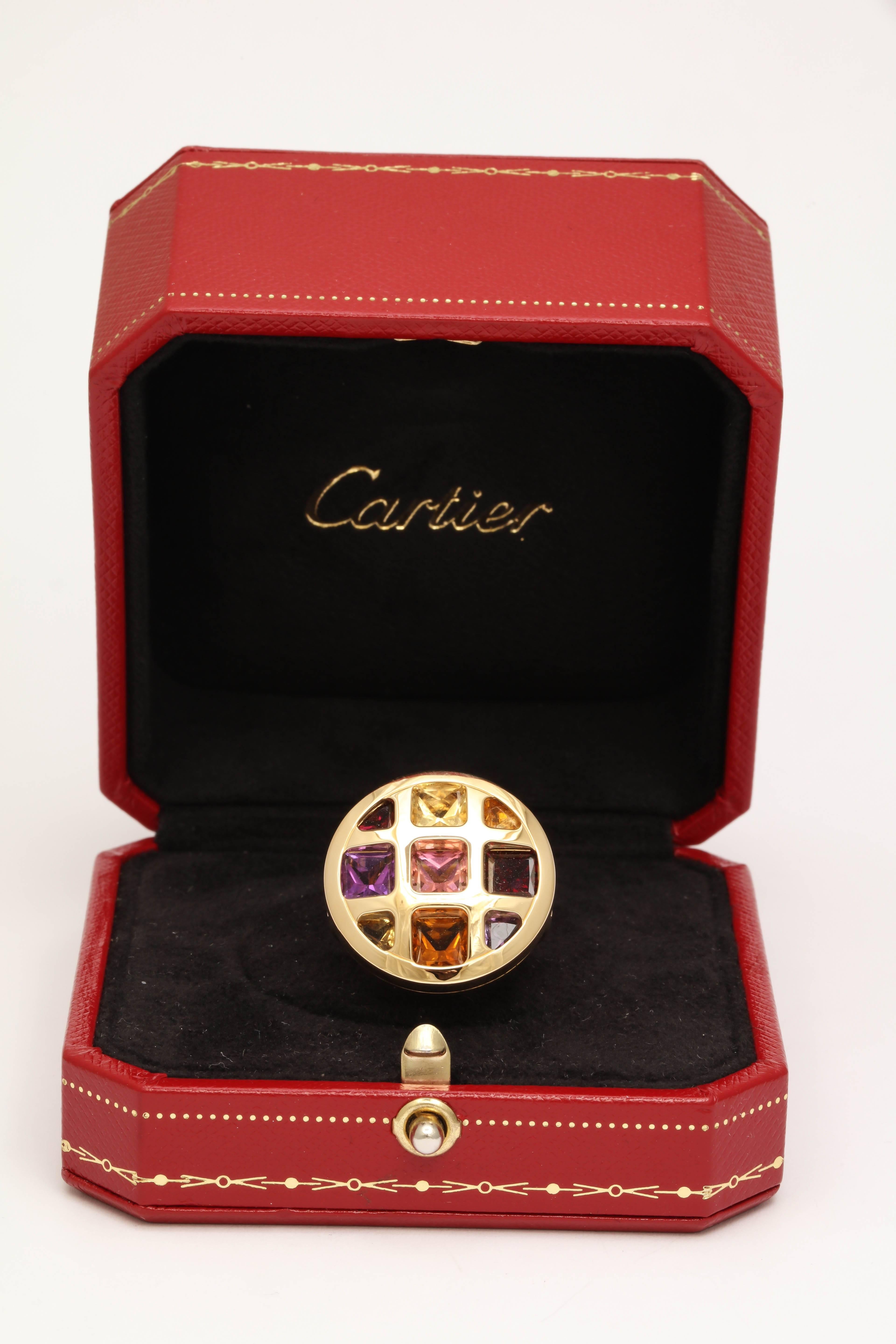 18kt Yellow Gold Circular Waffle And Tic-Tac-Toe Design Ring Embellished With French Cut Citrine,Garnet,Pink Tourmaline And Amethyst Stones.Made In Paris By Cartier In The 1990's.Serial # NM 0232. Size 52, American Size 6.Comes With Original