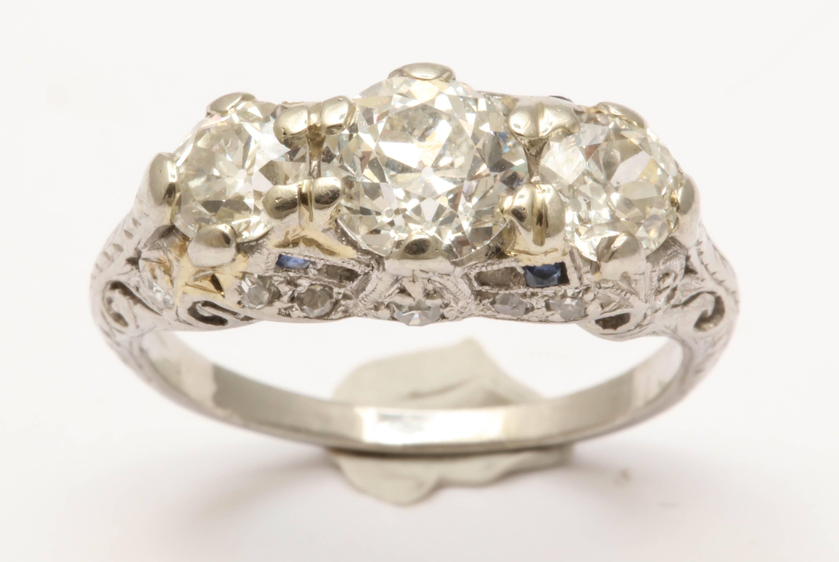 One Ladies Art Deco Three Stone Past,Present And Future Ring Embellished With Three Old European Cut : Center Stone Approximate Weight = .90cts H-I Color VS2 Quality. Two Side Diamonds Approximate Weight .50Cts Each Stone With An approximate Color