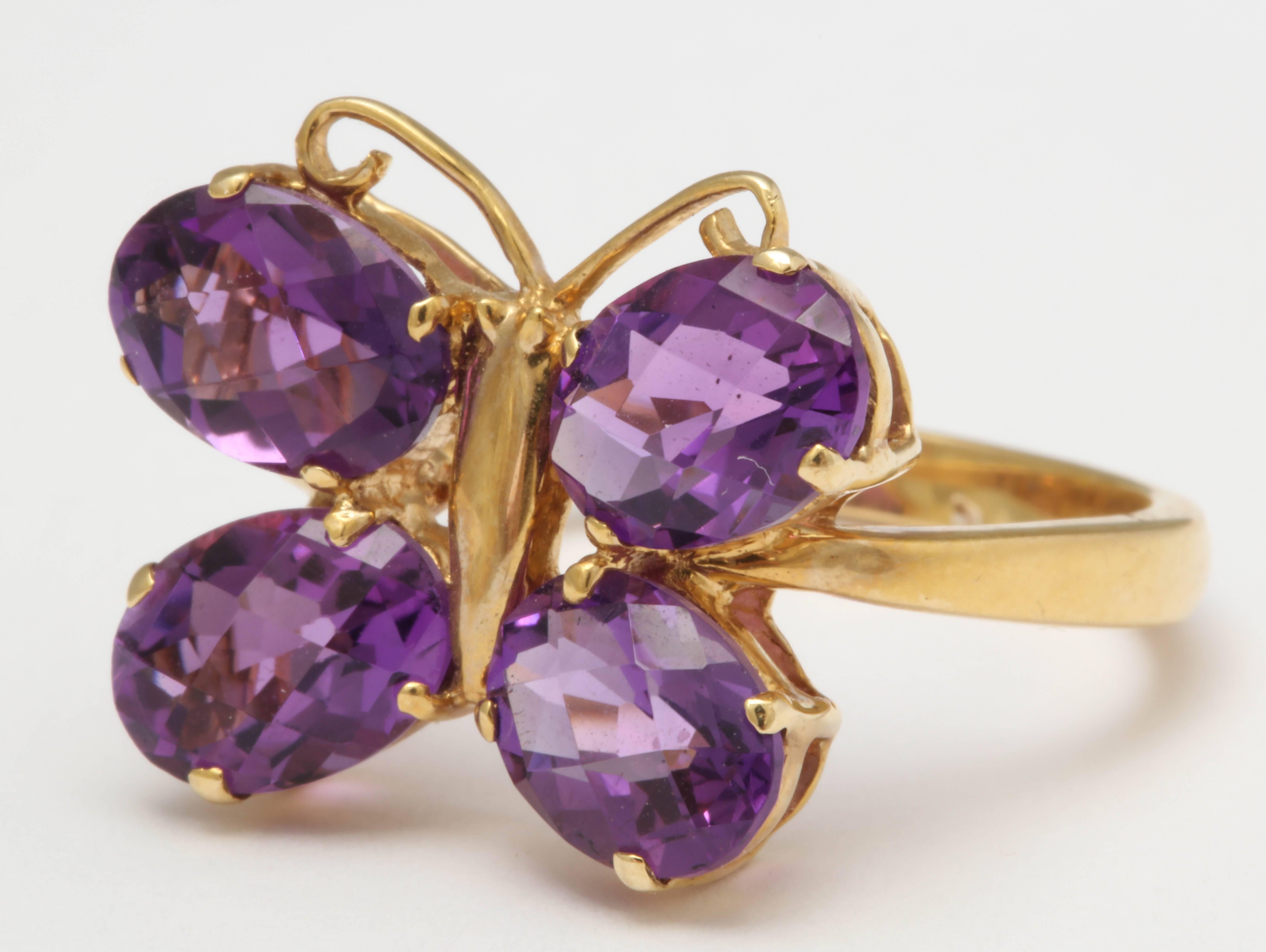 The wings of this  cute butterfly are set with 4 matching faceted amethyst ovals. The body of the butterfly and the shank of the ring are 14 kt yellow gold. The size of the ring is 8-8.5 and can be sized. This ring matches earrings