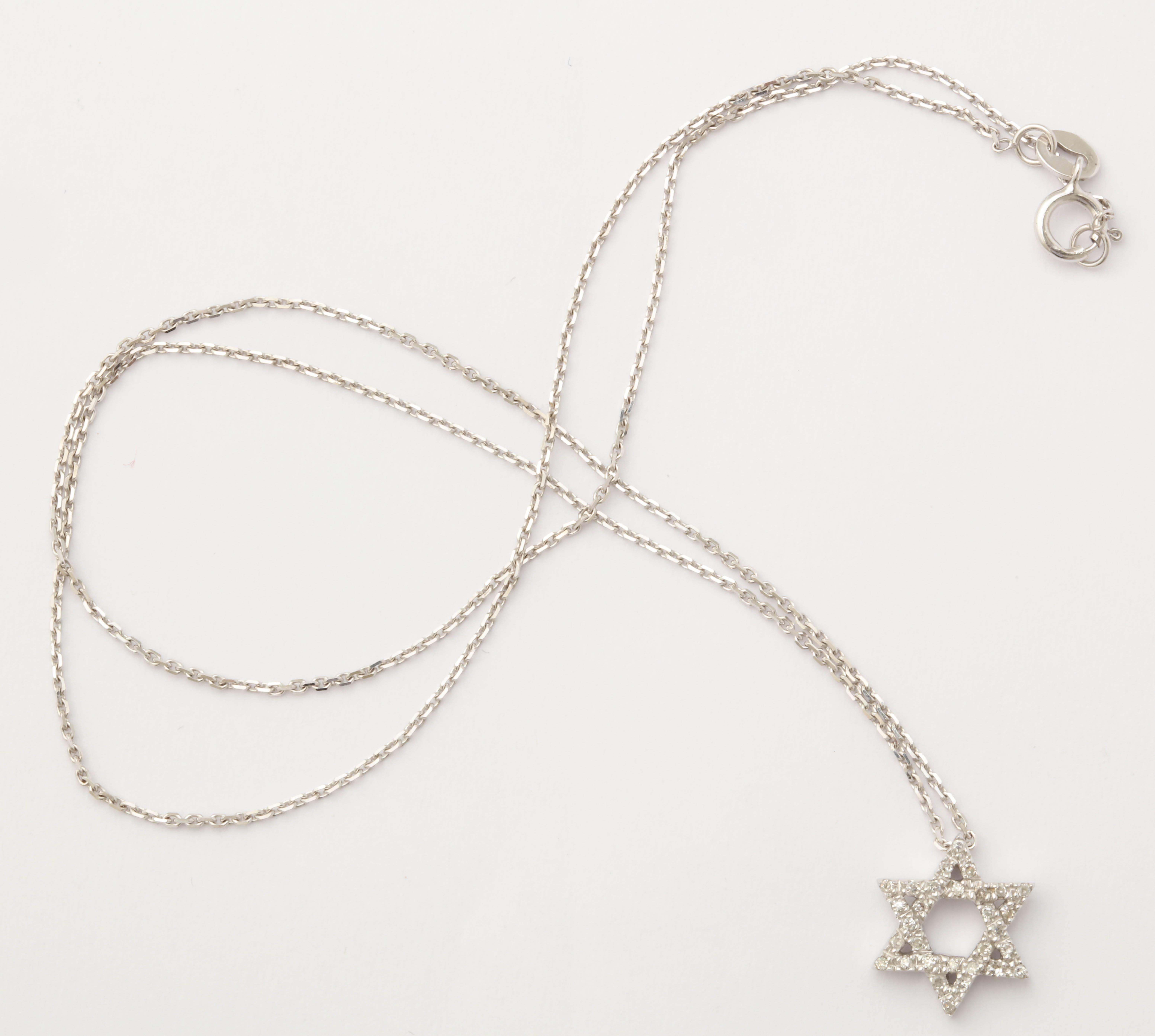 This lovely 14 kt gold  Star of David is 1/2 in. across and has .52 cts white diamonds. The 14kt chain is 16 in. and is included,