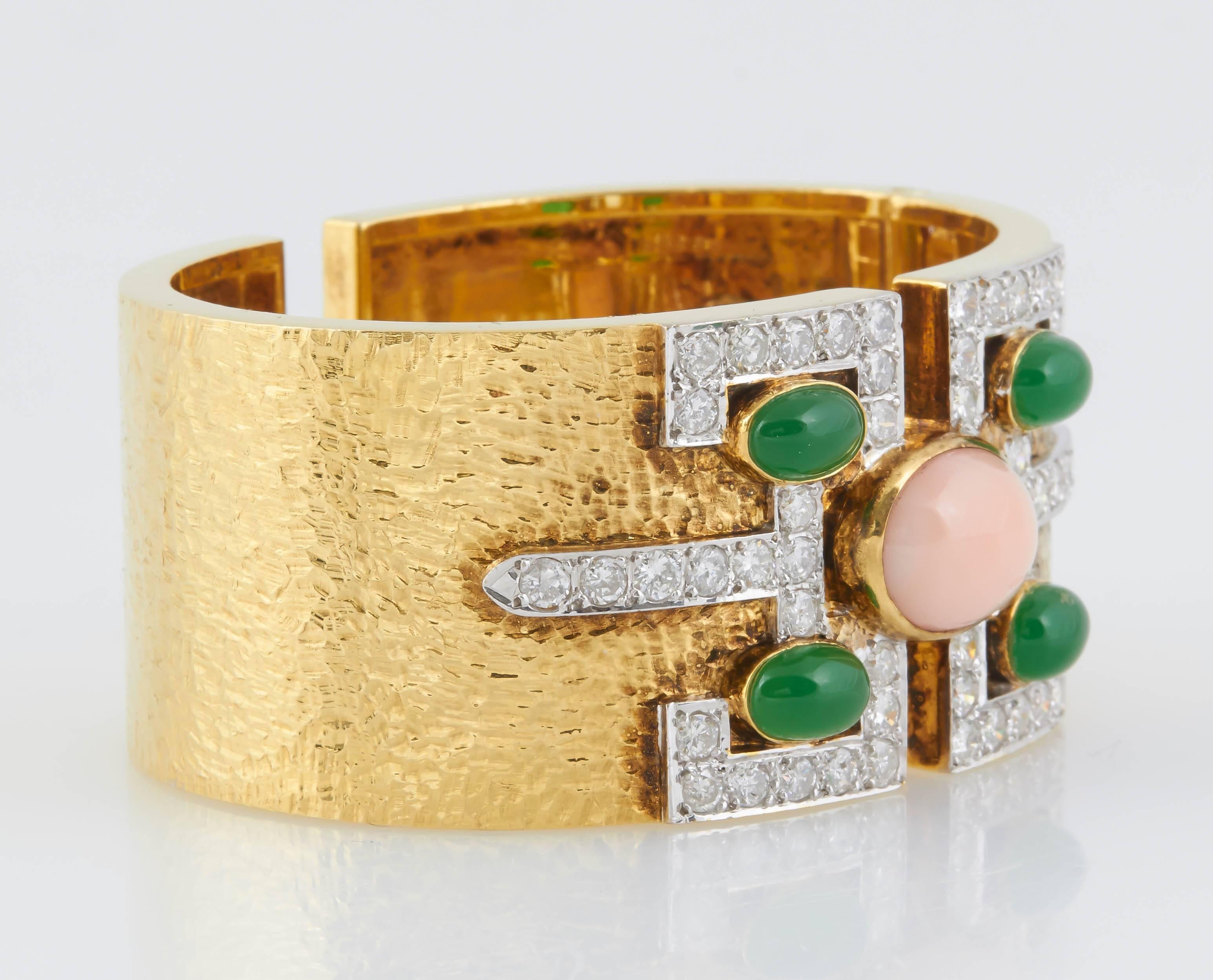 Stylish 18K yellow gold cuff bracelet, featuring a Coral at the center with 4 green onyx stones at each corner. 48 dazzling round cut diamonds (6.50 cts) accentuate the colored stones.  