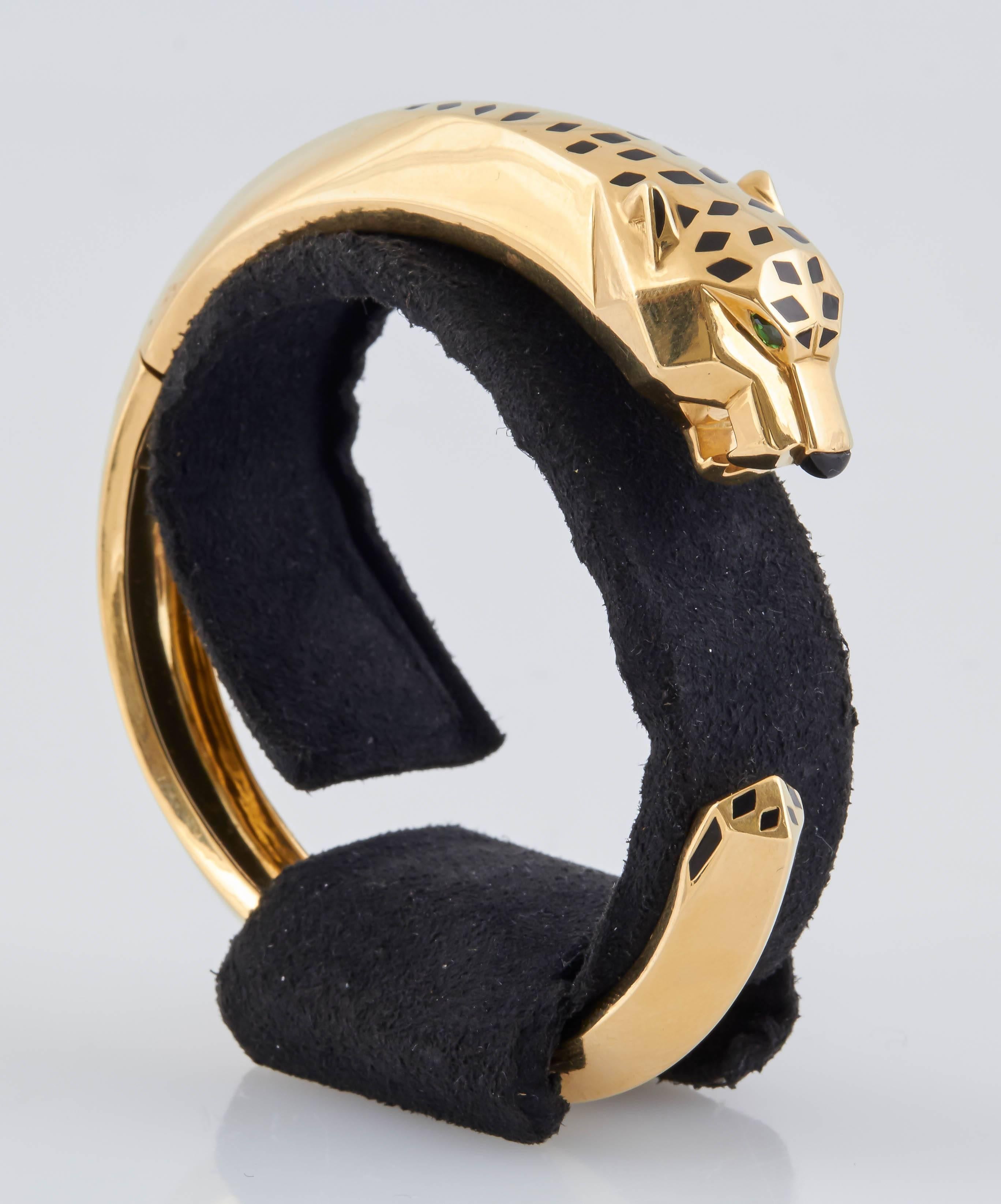 This gorgeous iconic piece is from Cartier's Panthere Collection. Shaped in the likeness of a panther, this signed bracelet is finely crafted in 18K yellow gold. Covered with Black lacquer spots, the panther's head is accentuated by a black onyx