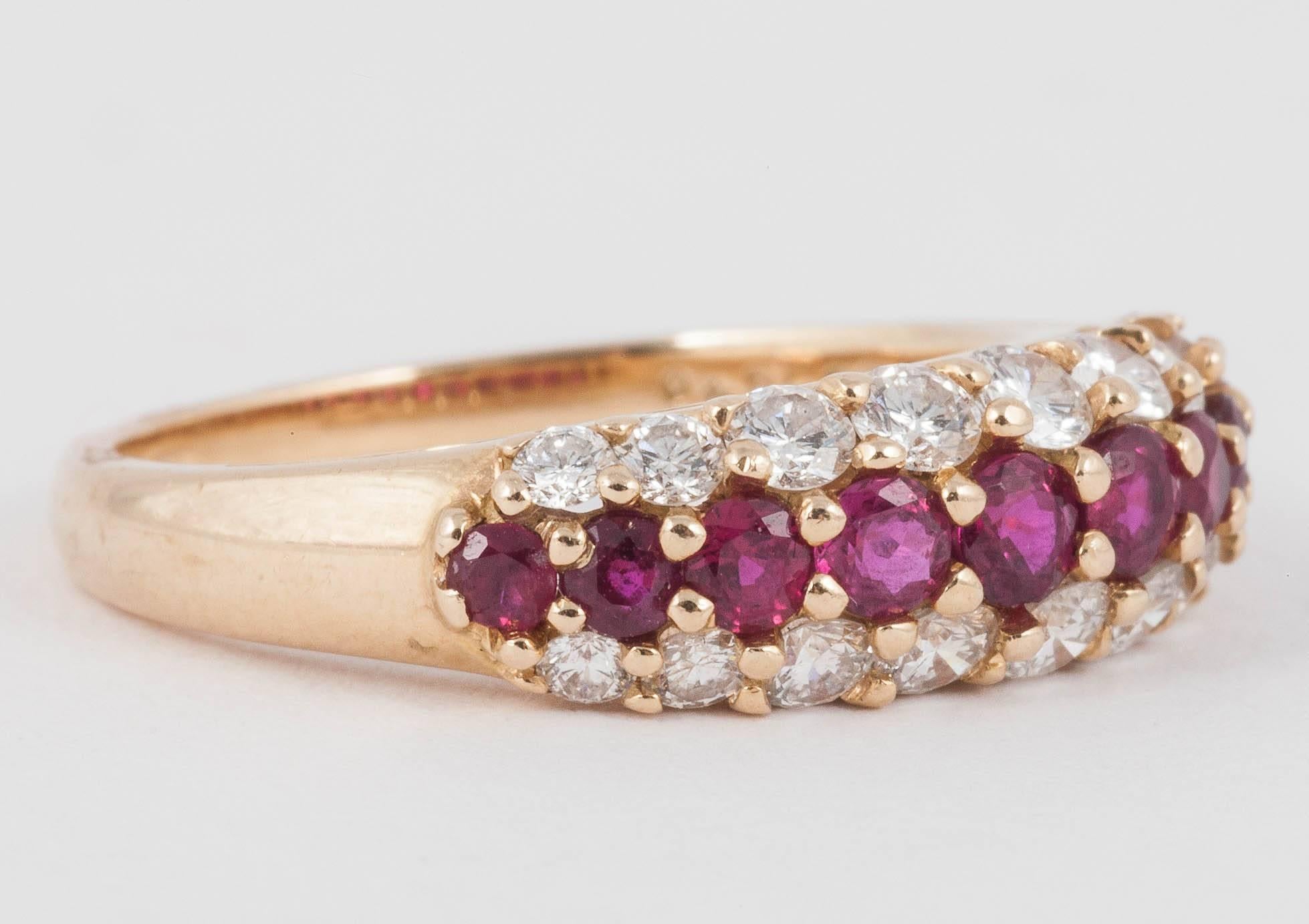 Oscar Haymen Ruby and Diamond ring set in 18ct Gold. 10 natural Rubies encased with 2 rows of Diamonds
Finger size 8