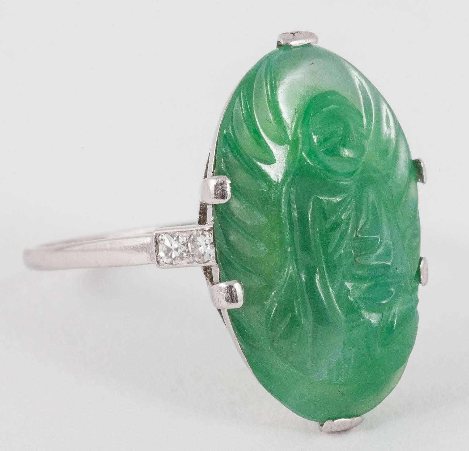 Fine carved ring in natural Jadeite set in white Gold with 2 single cut Diamonds on each shoulder

Finger size T