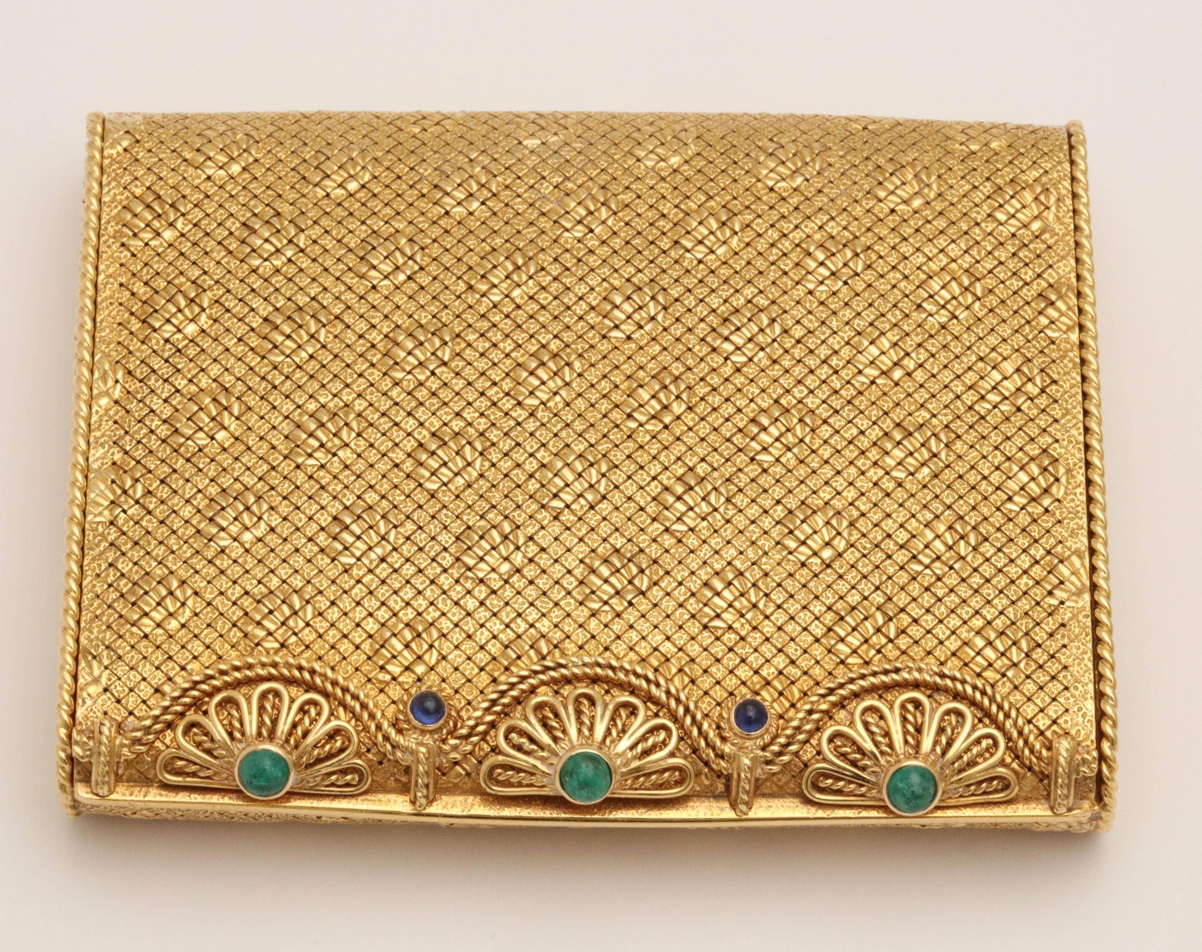 Very elegant VCA 18kts woven Yellow Gold & brocaded pattern Compact.
Made in the 1960 - when all you needed was your compact and your jewels.
The opening spans the compact and is set with 3 Cabochon Emeralds and 2 Ca
bochon Sapphires nestled in