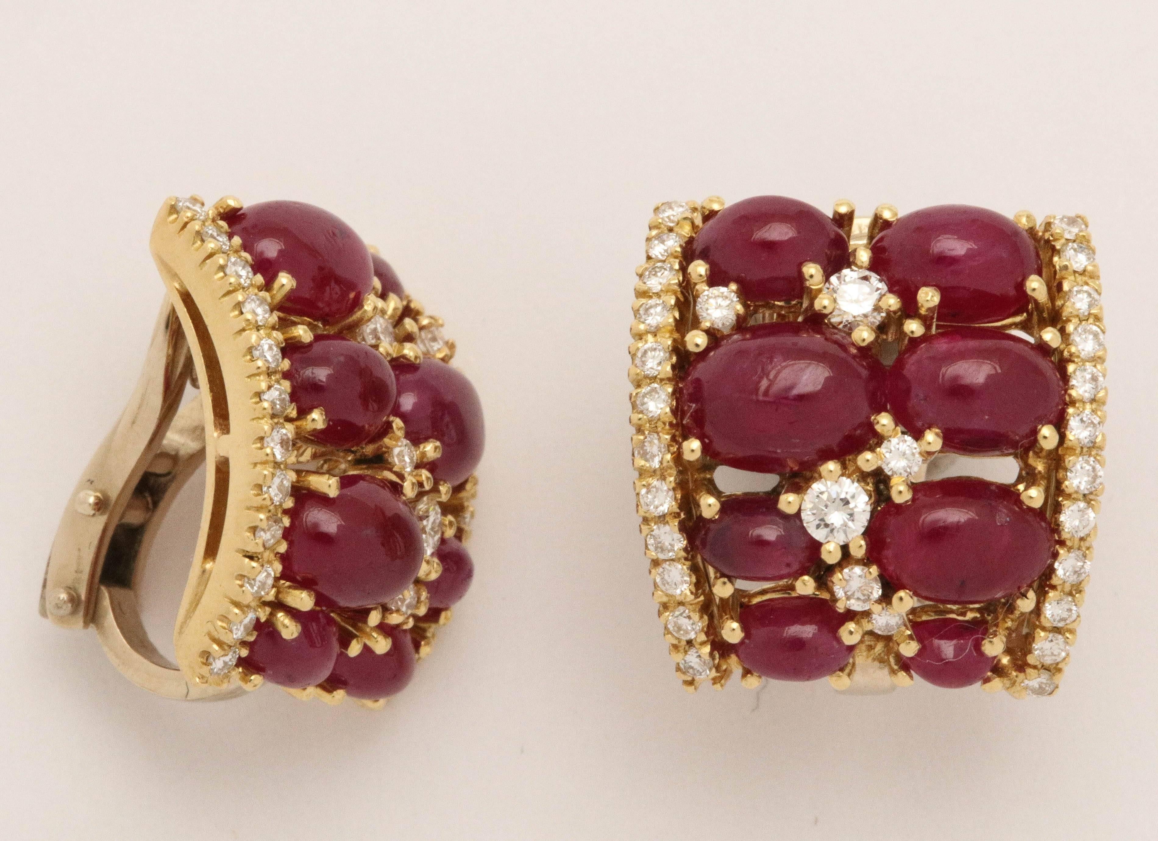 Opulent Cabochon Burma Ruby & Diamond Earrings set in 18kt Yellow Gold.
Hugging close to the Ear and bordered on each side by a row of Diamonds while having five diamonds sprinkled amongst the Rubies. A garden vision!
Wow - what a look.  Full of