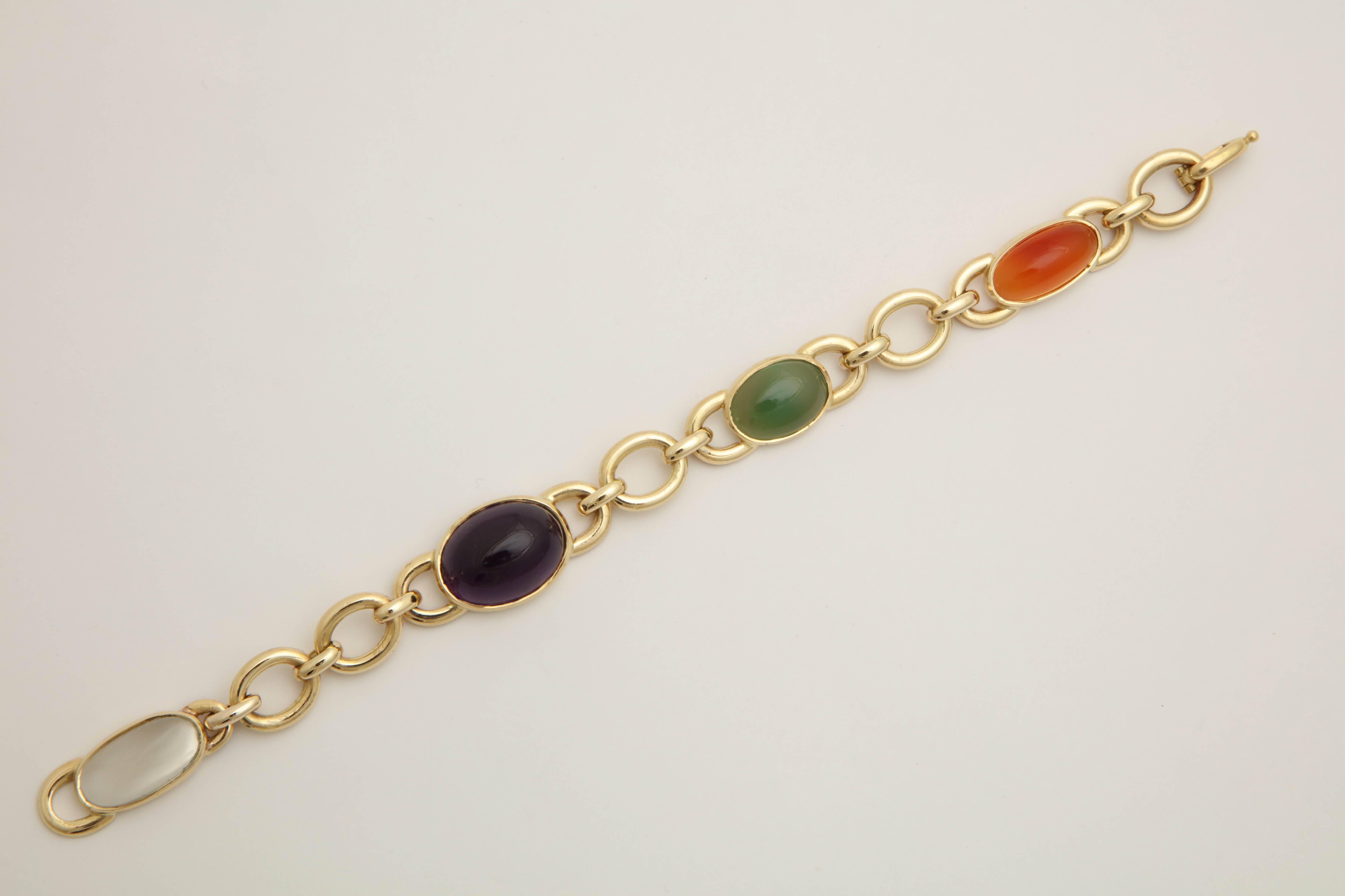 18kt Yellow Link Bracelet Designed With Four Semi Precious Bezel Set Cabochon Stones Consisting Of One Amethyst One Carnelian One Jadeite And One Moonstone.Beautiful And Wearable Link Design Created In Austria In The 1960's.Finished Off with a