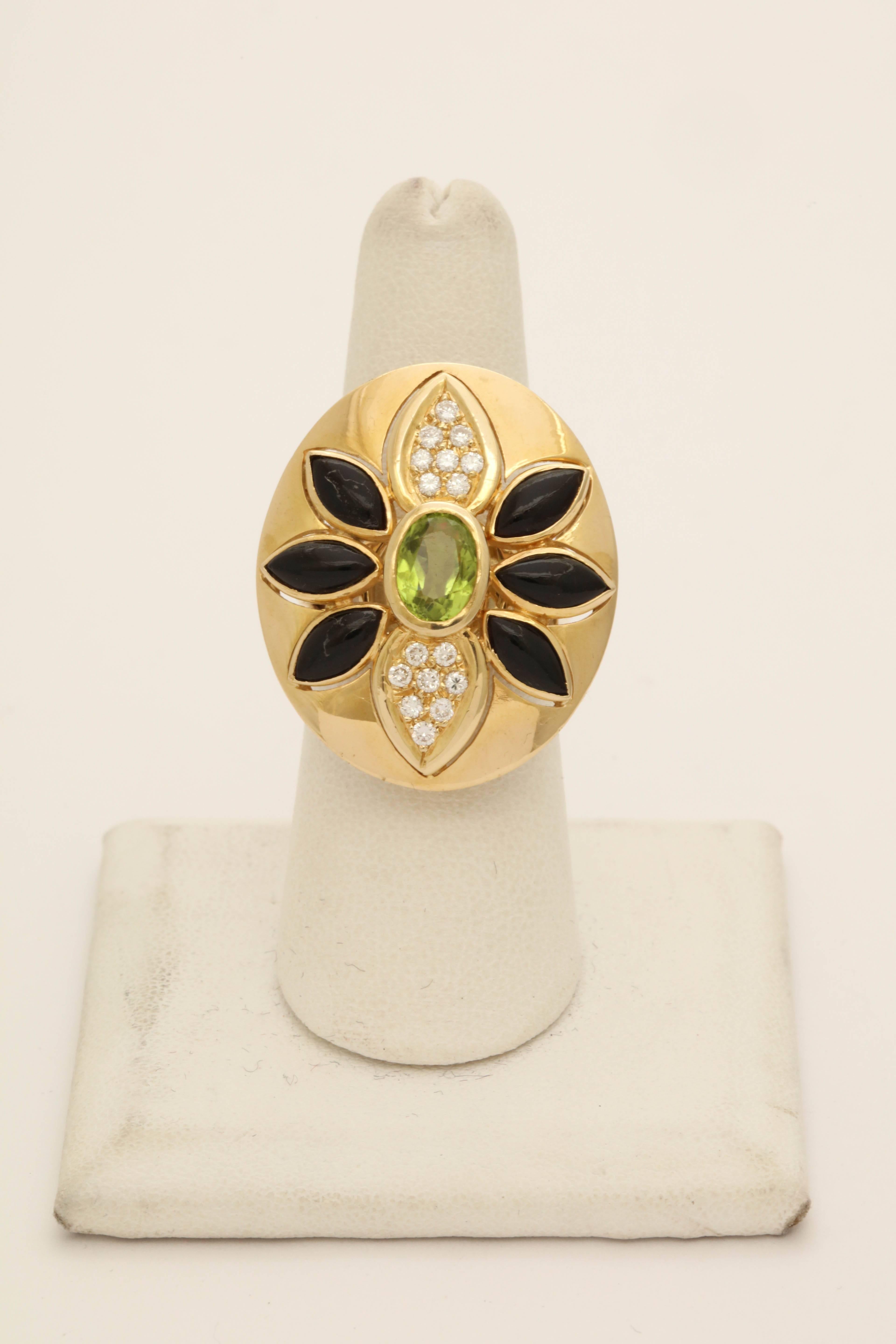 One Ladies Large Cocktail Ring Embellished With A 1.50 Ct Bezel set Faceted Peridot Stone.Further Decorated With Six Bezel Set Marquis Cut Onyxes With 16 Full Cut Diamonds Weighing Approximately .50 cts total Weight.The Design Resembles A Floral