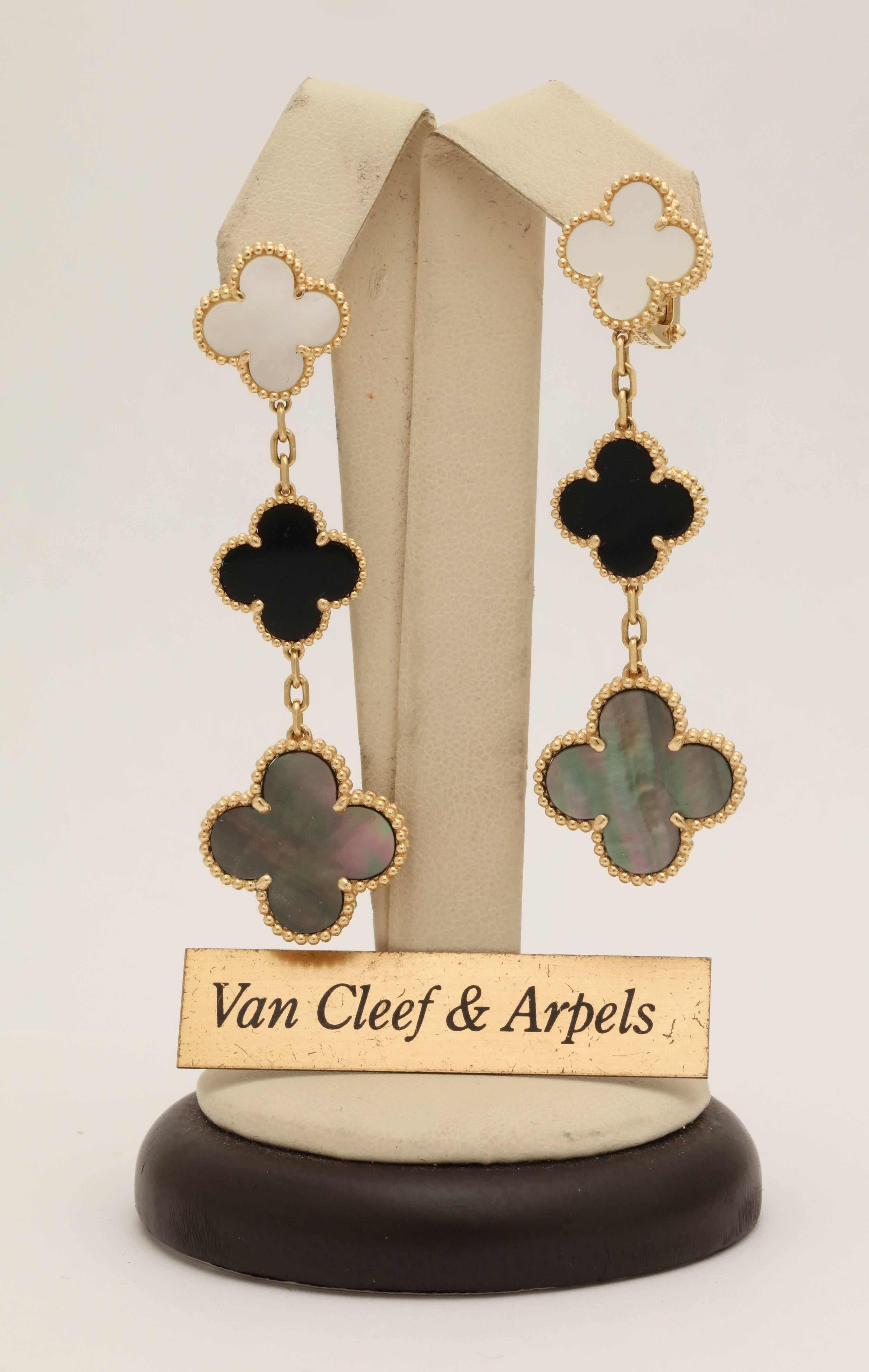 One Pair Of Ladies 18kt Yellow Gold Alhambra Dangle Earclips Composed Of Three Different Floral Tiers Of Onyx And White Mother Of Pearl Clovers And Dark Mother Of Pearl Clovers On The Bottom Of The earrings. Note: Earrings Are For Pierced Ears And