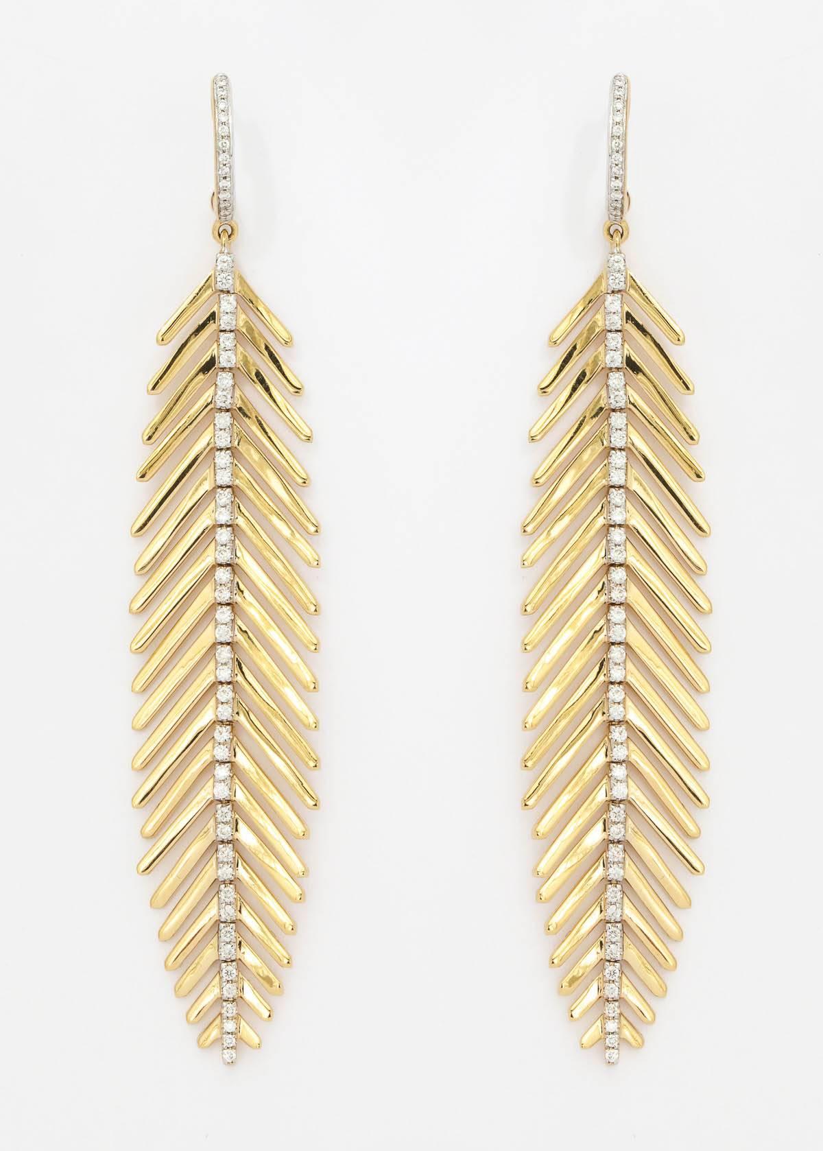 18k yellow gold and diamond spine articulated feather design earrings containing 110 full cut diamonds weighing 0.70 ct. total weight.  These earrings are 3" in length .