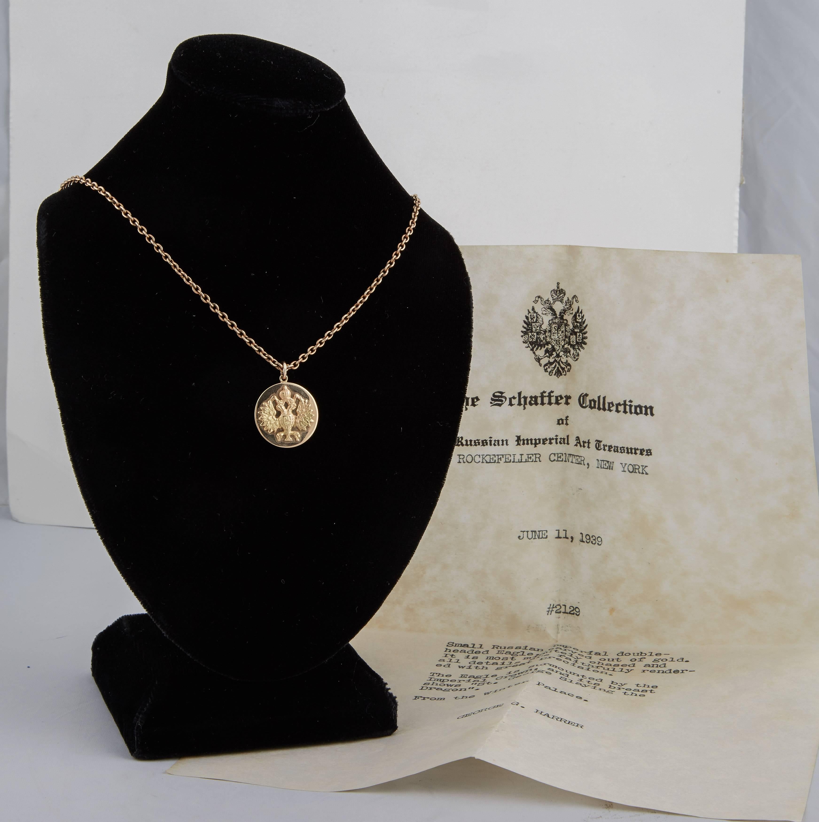 The eagle of yellow gold from the Romanov era, mounted on a circular solid rose gold disc, attached to a gold suspension ring. Chain not included. 

Sold together with original document from The Schaffer Collection of Russian Imperial Art Treasures,
