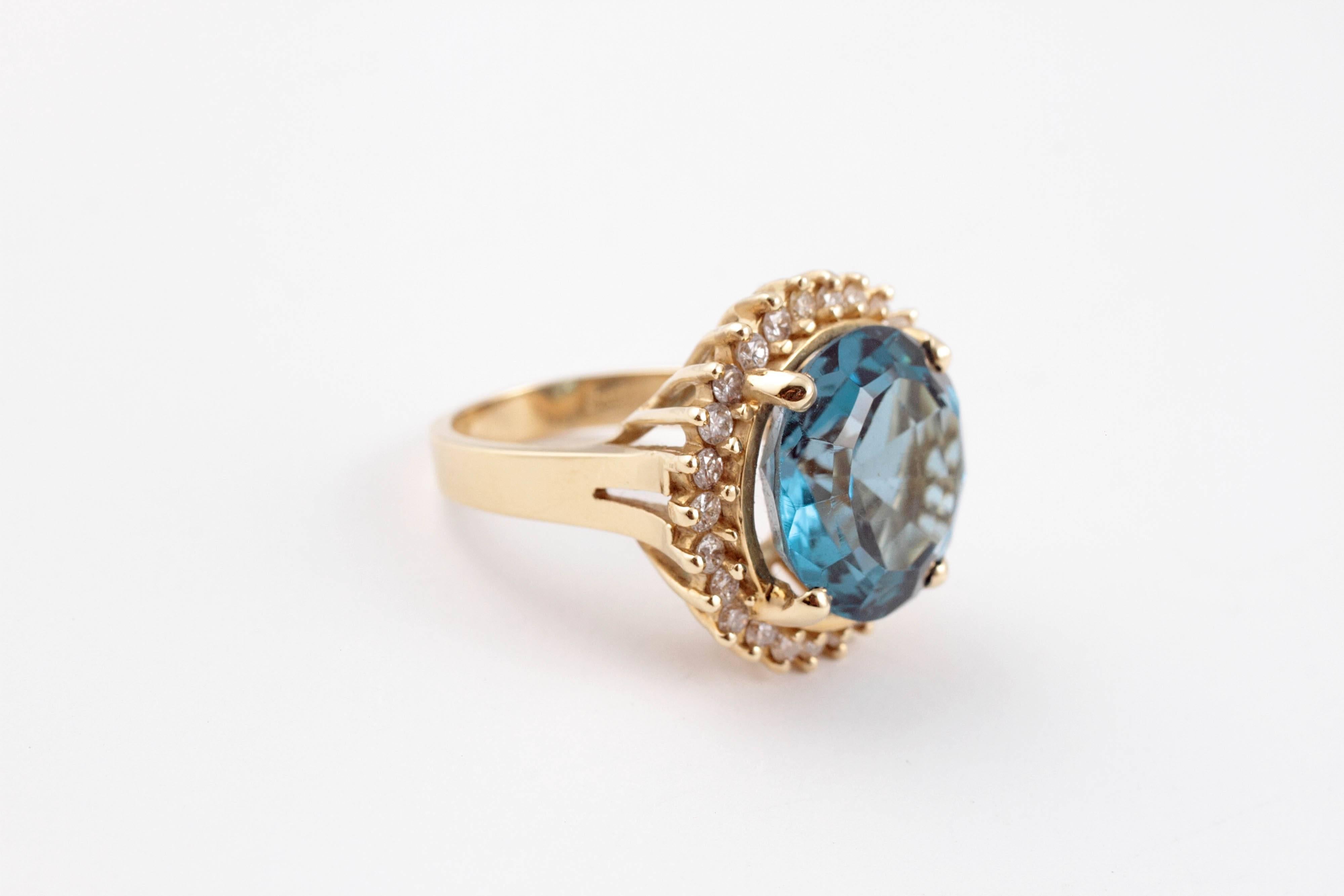 A knockout for sure! In a size 6 1/2, 14 karat yellow gold centered with a 12.00 ct blue topaz, surrounded by 0.75 cts of diamonds.