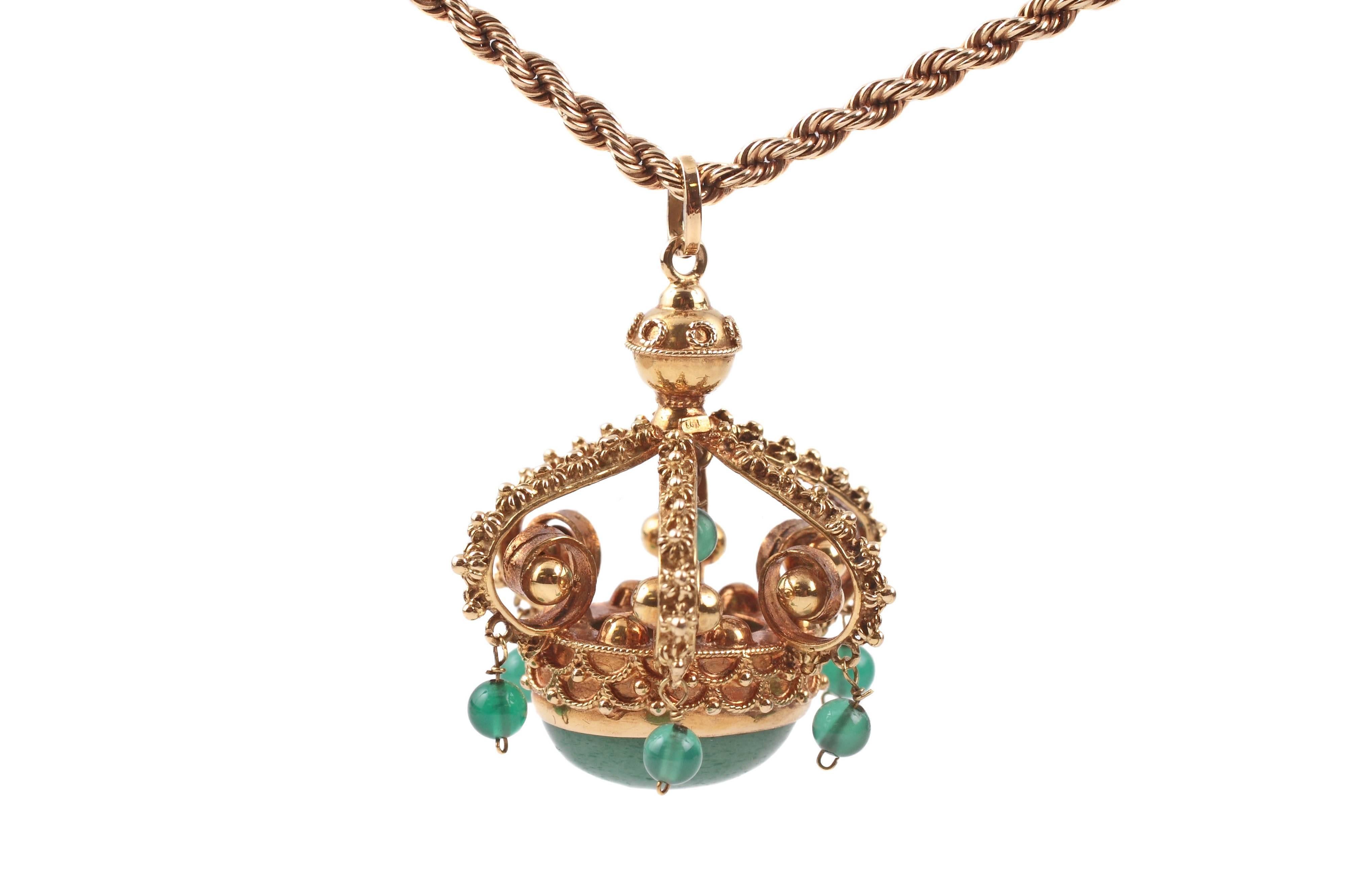 Intricately detailed crown pendant with green aventurine accents, in 14 karat yellow gold.