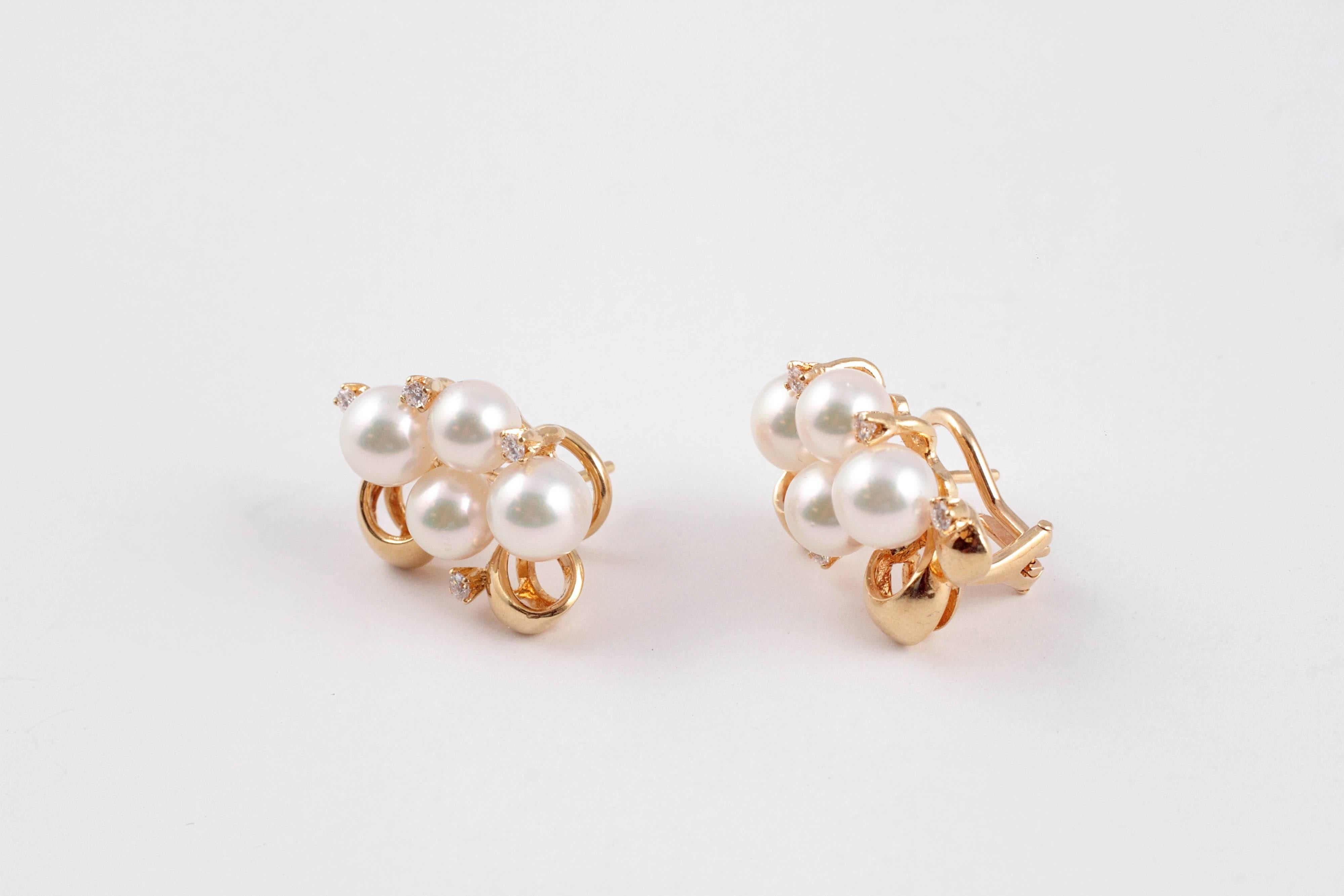 Classically designed Mikimoto cultured pearls and diamond earrings with omega backs.  Set in 18 karat gold.