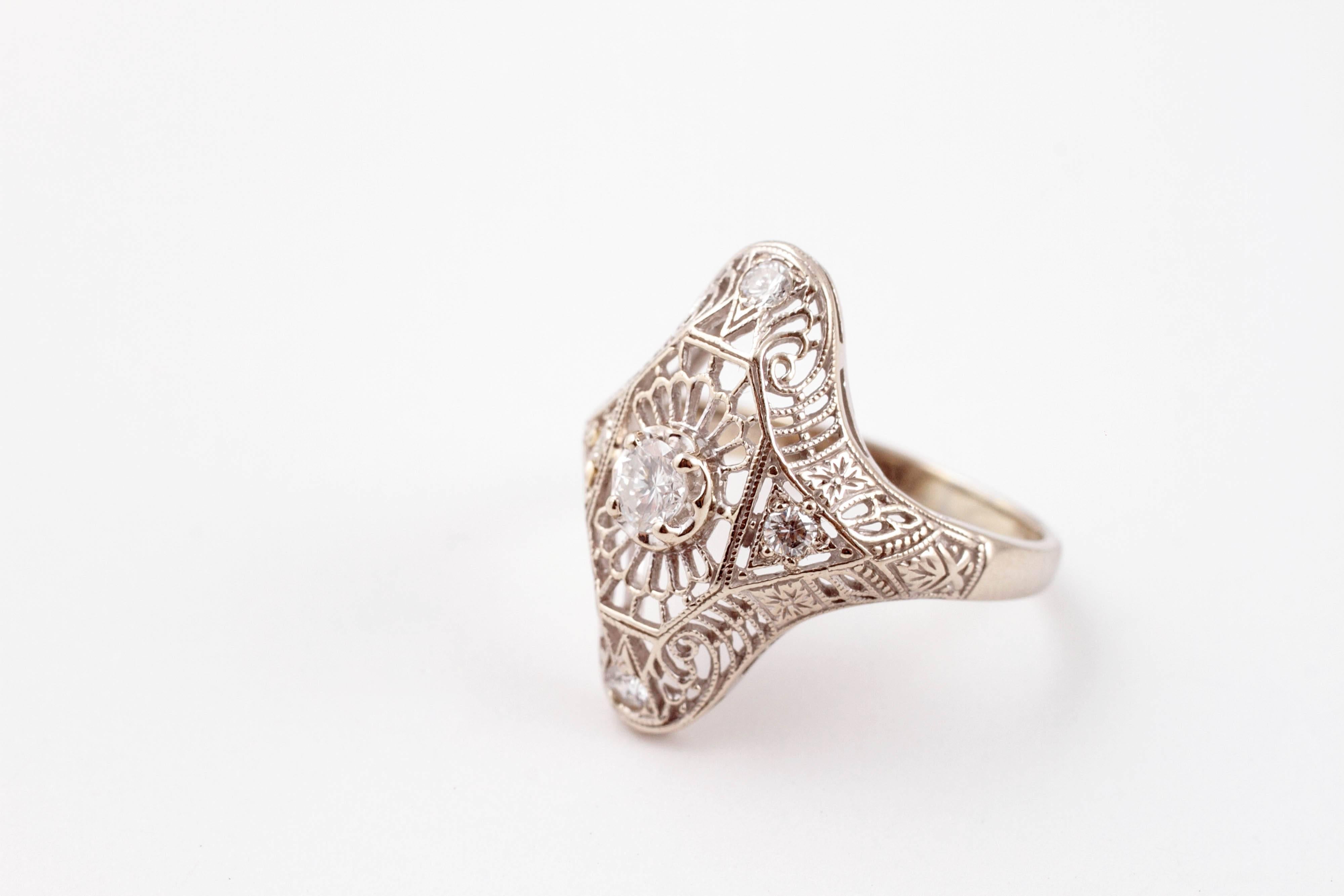 This Art Deco .25 carat diamond filigree ring in 14 karat white gold is the perfect gift for any estate jewelry lover!  Size 7.