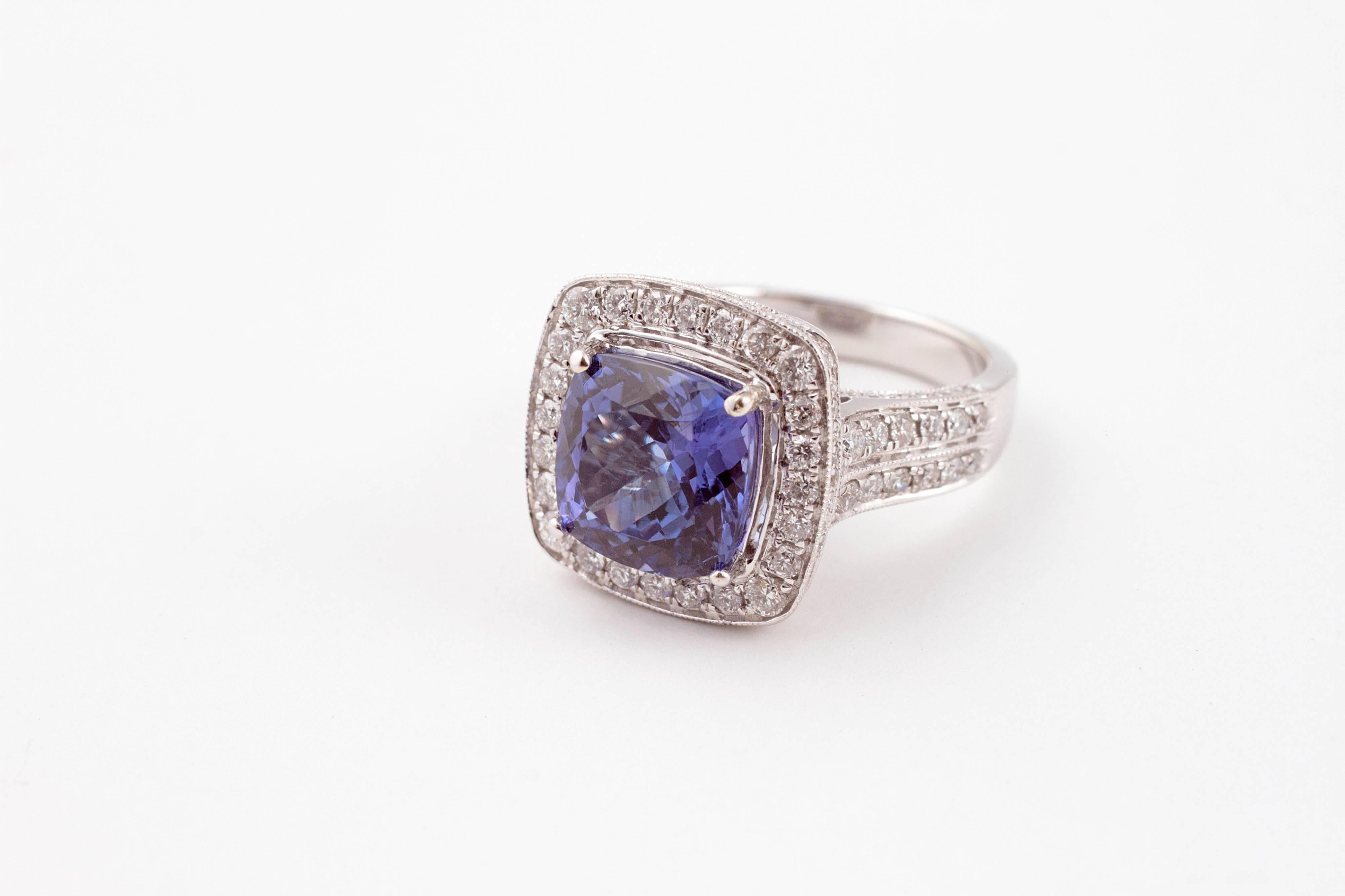 Cushion cut 4.74 carat tanzanite with 1.75 carats of diamonds set in 18 karat white gold.  Size 6 1/2.