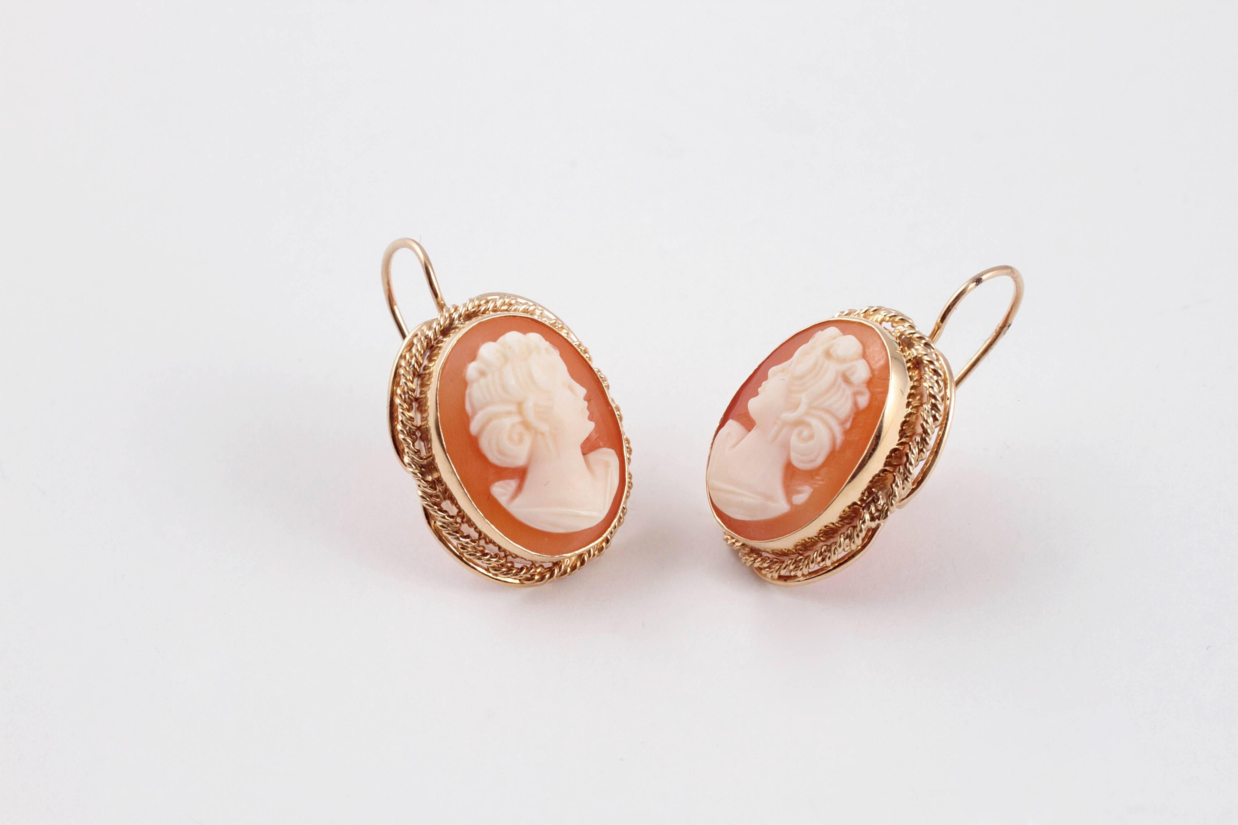 Shell cameos encased in a rope detailed 14 karat yellow gold frame, and suspended by euro wire.